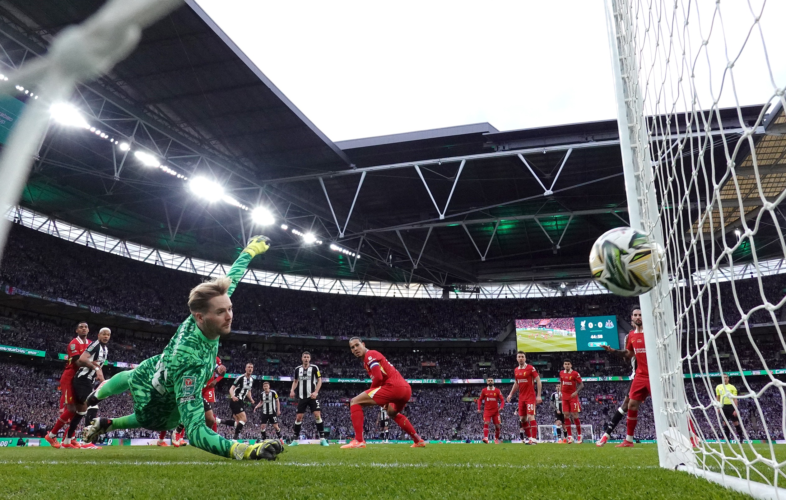 Dan Burn scores a headed goal against Liverpool at Wembley Stadium.