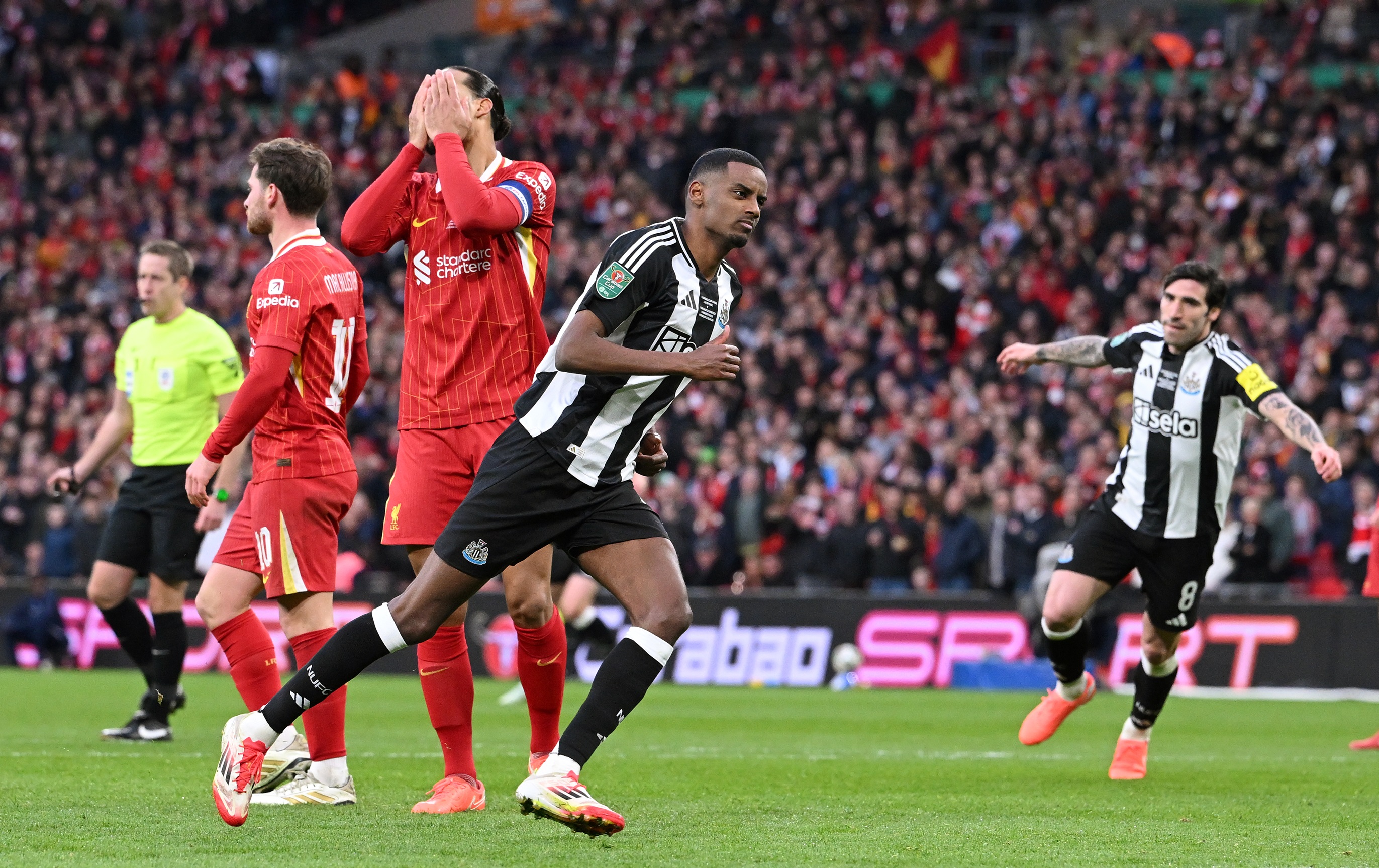 Liverpool players look deflated after Alexander Isak goal for Newcastle.