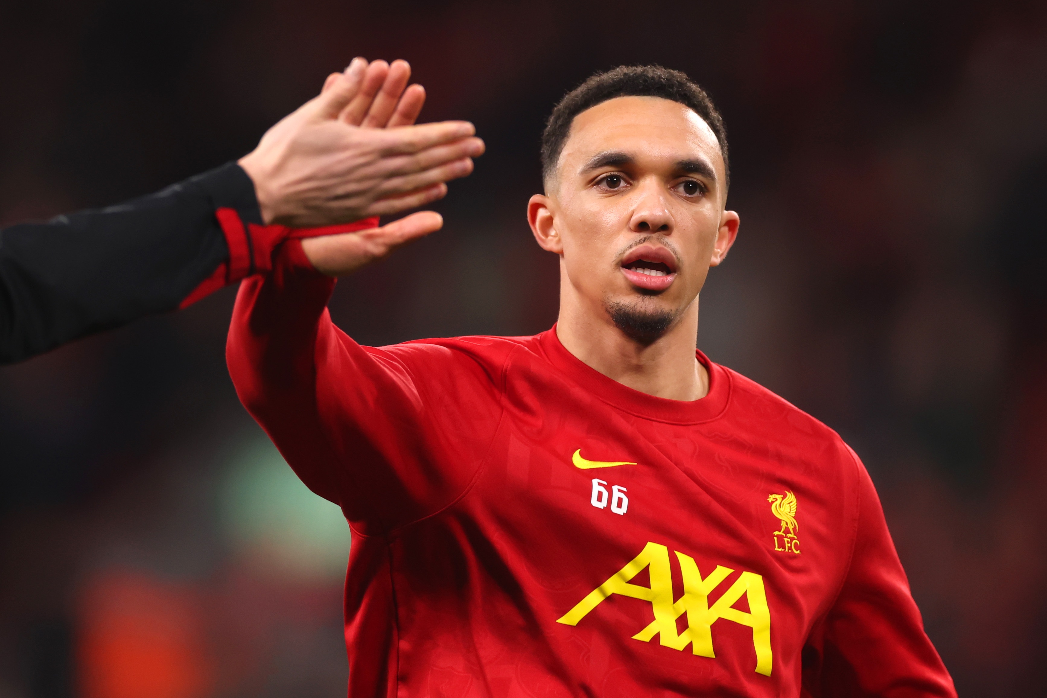 Trent Alexander-Arnold high fives a Liverpool teammate.