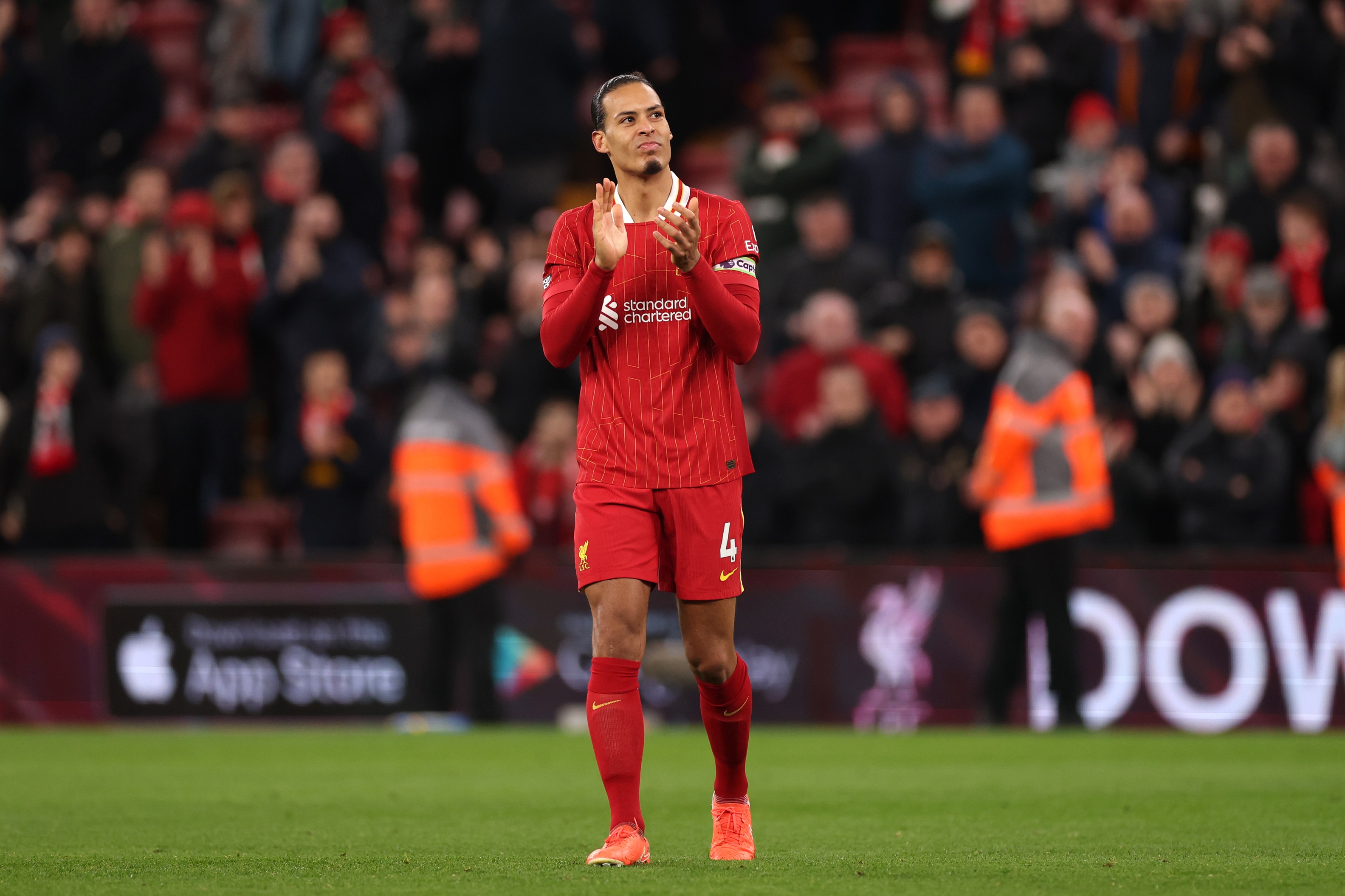 Virgil van Dijk claps Liverpool fans after a Premier League game with Newcastle.