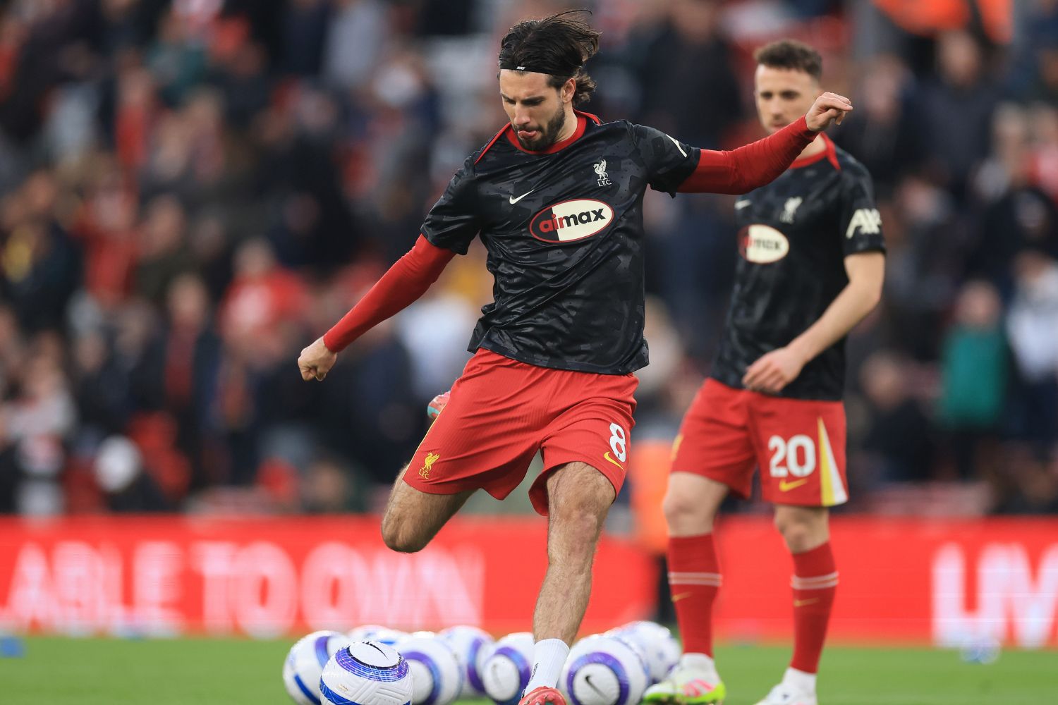 Dominik Szoboszlai warms up at Anfield