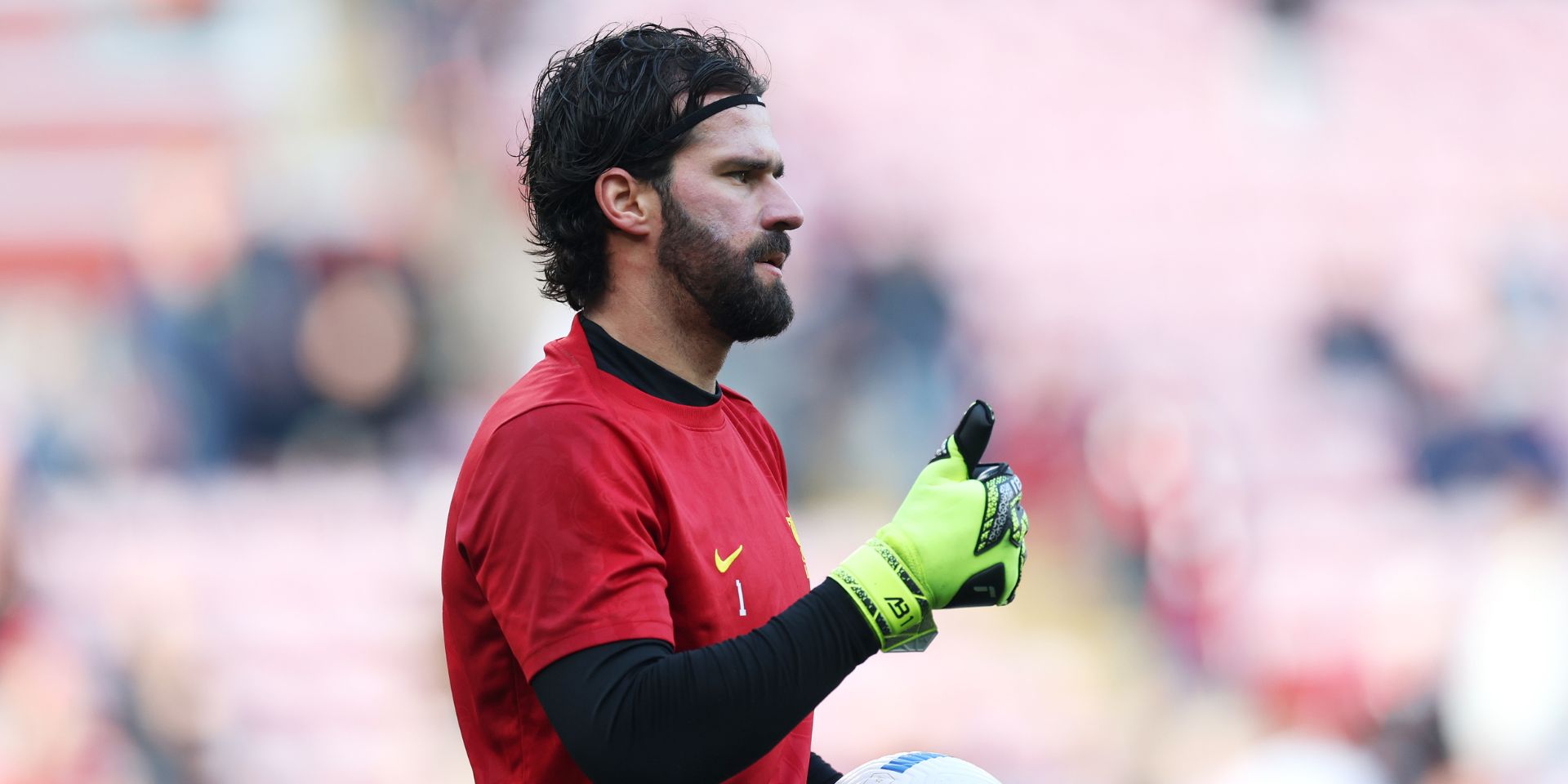 Alisson Becker warms up for Liverpool