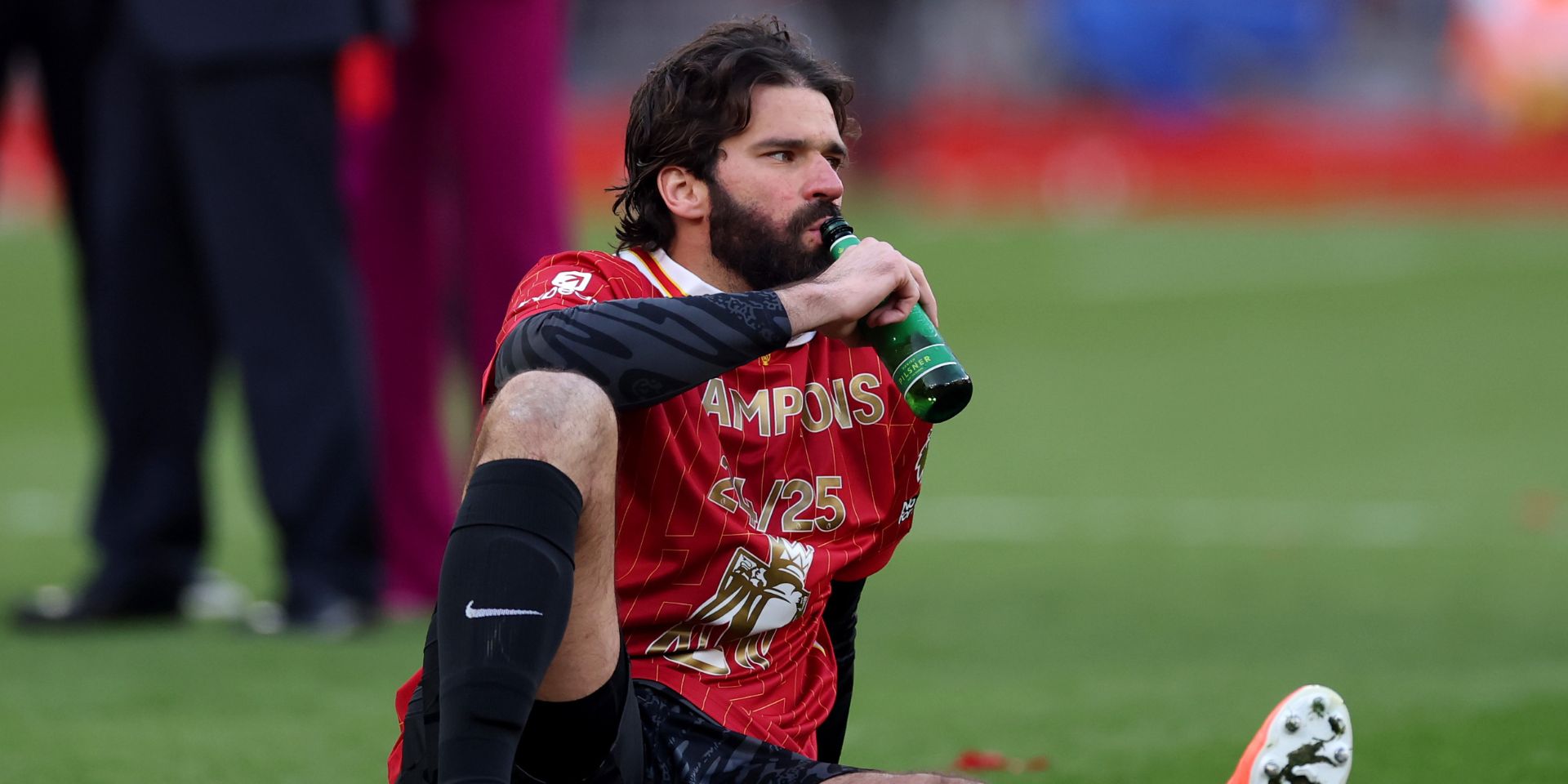 Alisson celebrates winning the league