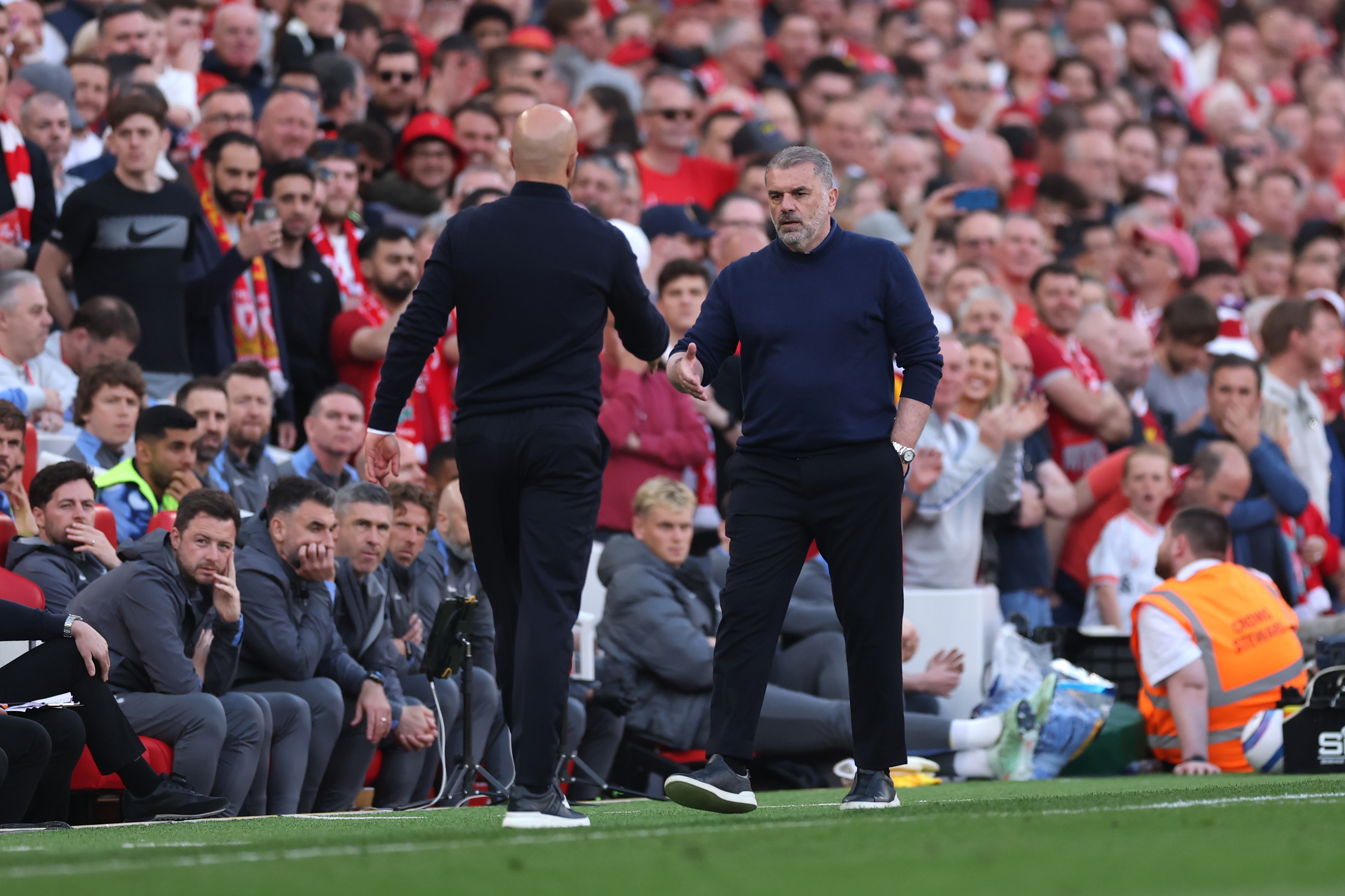 Ange Postecoglou and Arne Slot shake hands at Anfield.