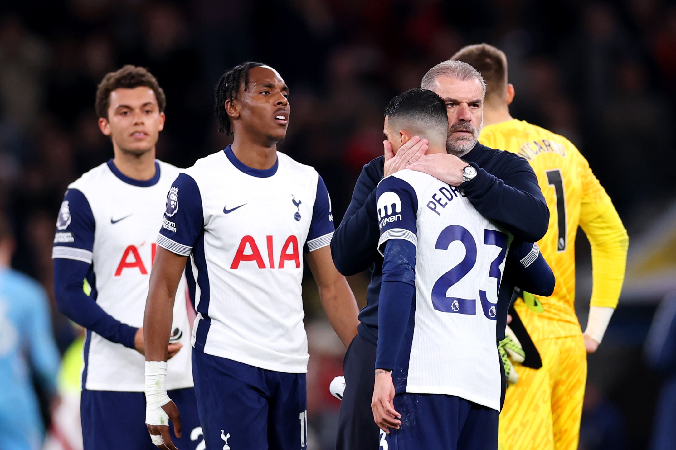 Ange Postecoglou hugs Pedro Porro and consoles upset Tottenham players.