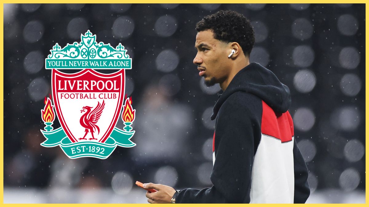 Hugo Ekitike holds his phone and looks at Liverpool club crest.