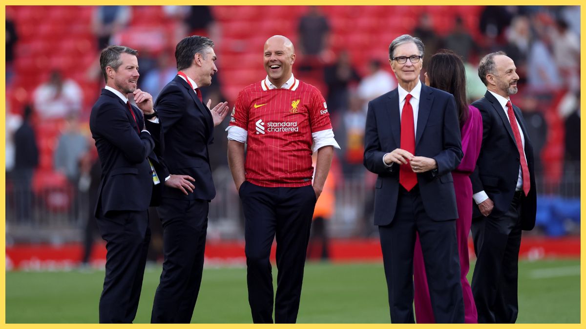 Liverpool owner John Henry stands next to head coach Arne Slot at Anfield.