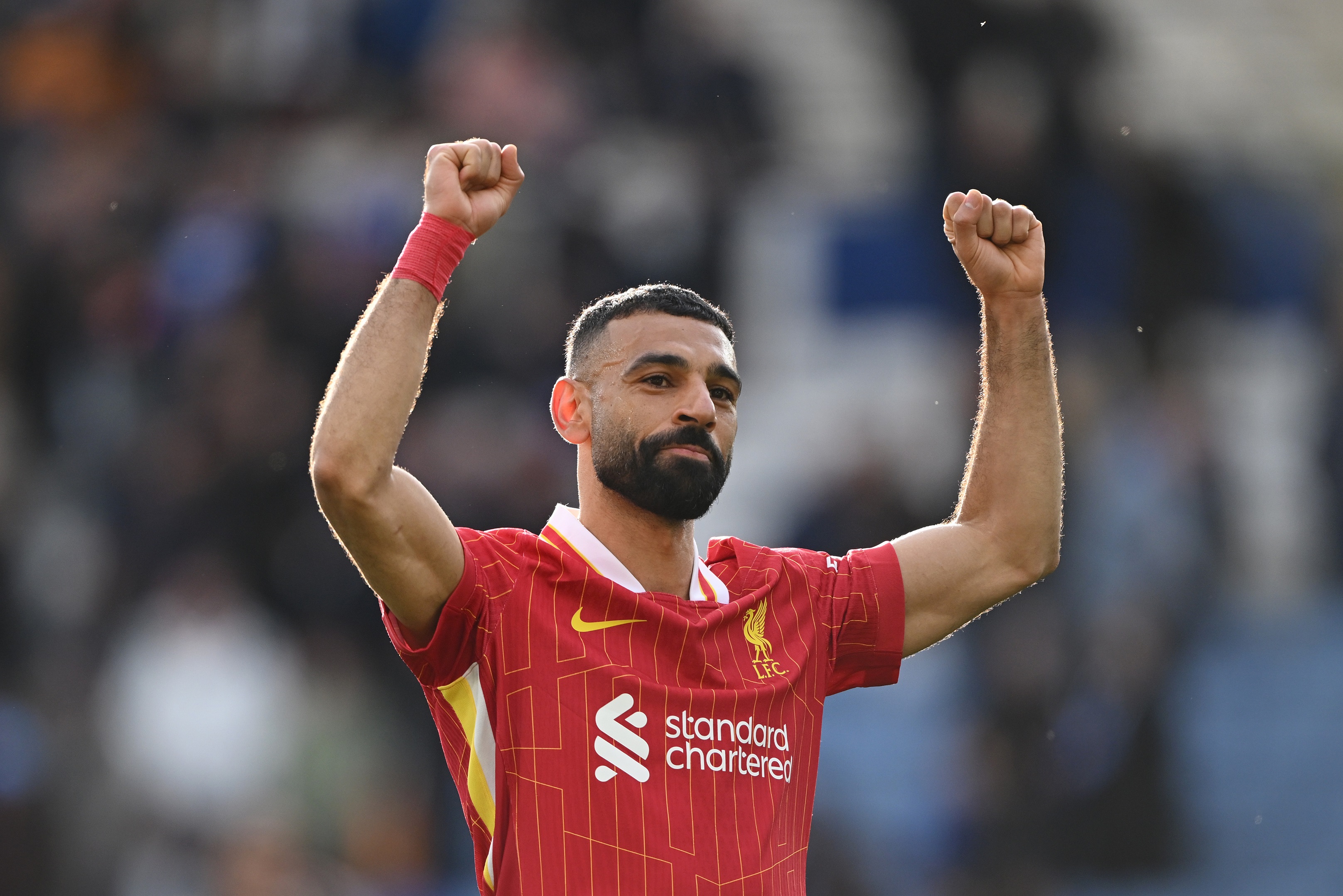 Mo Salah holds up his arms in celebration at the King Power Stadium.