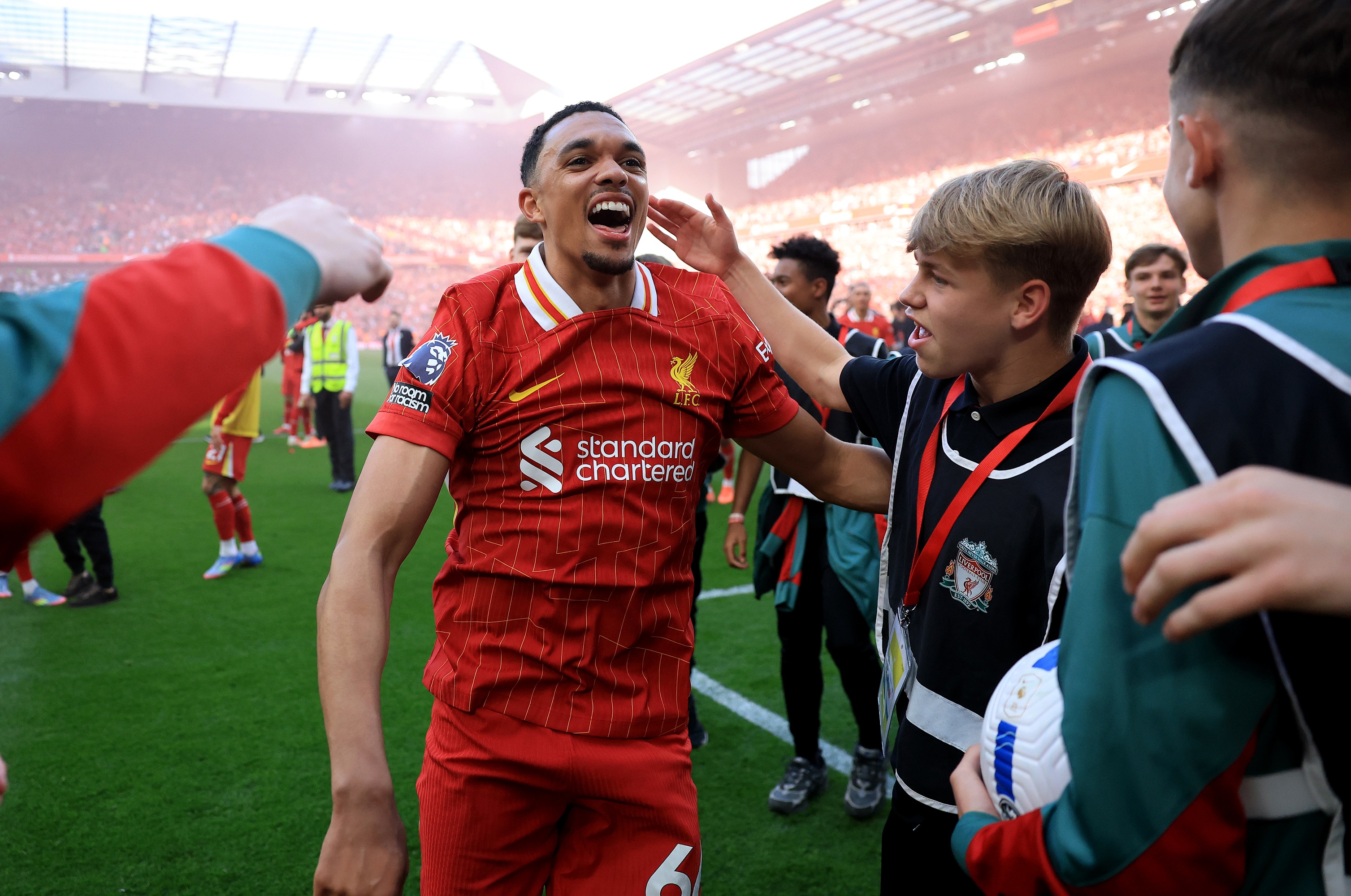 Trent Alexander-Arnold celebrates with Liverpool ball boy at Anfield.