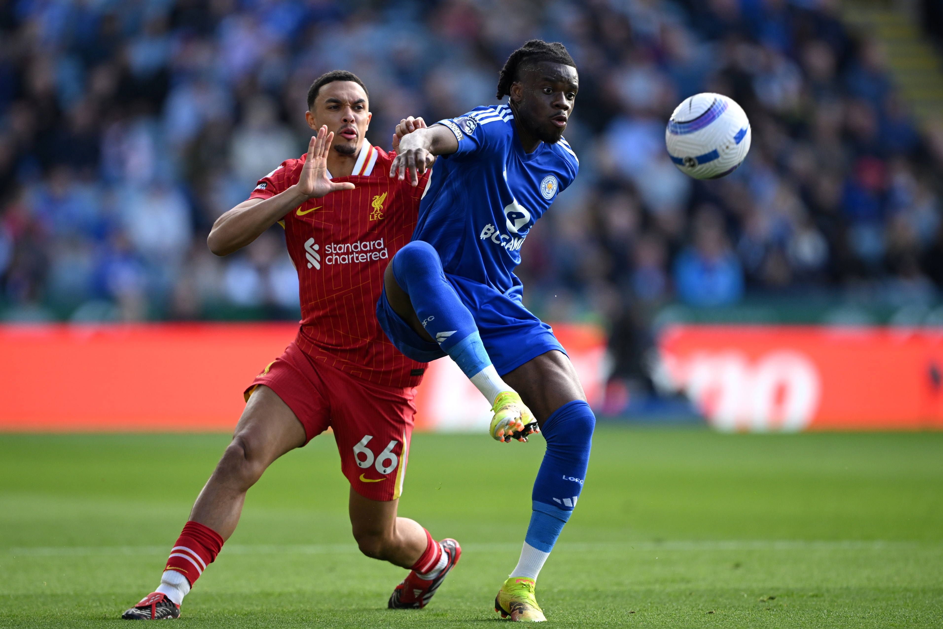 Trent Alexander-Arnold grapples with Stephy Mavididi during Leicester game.