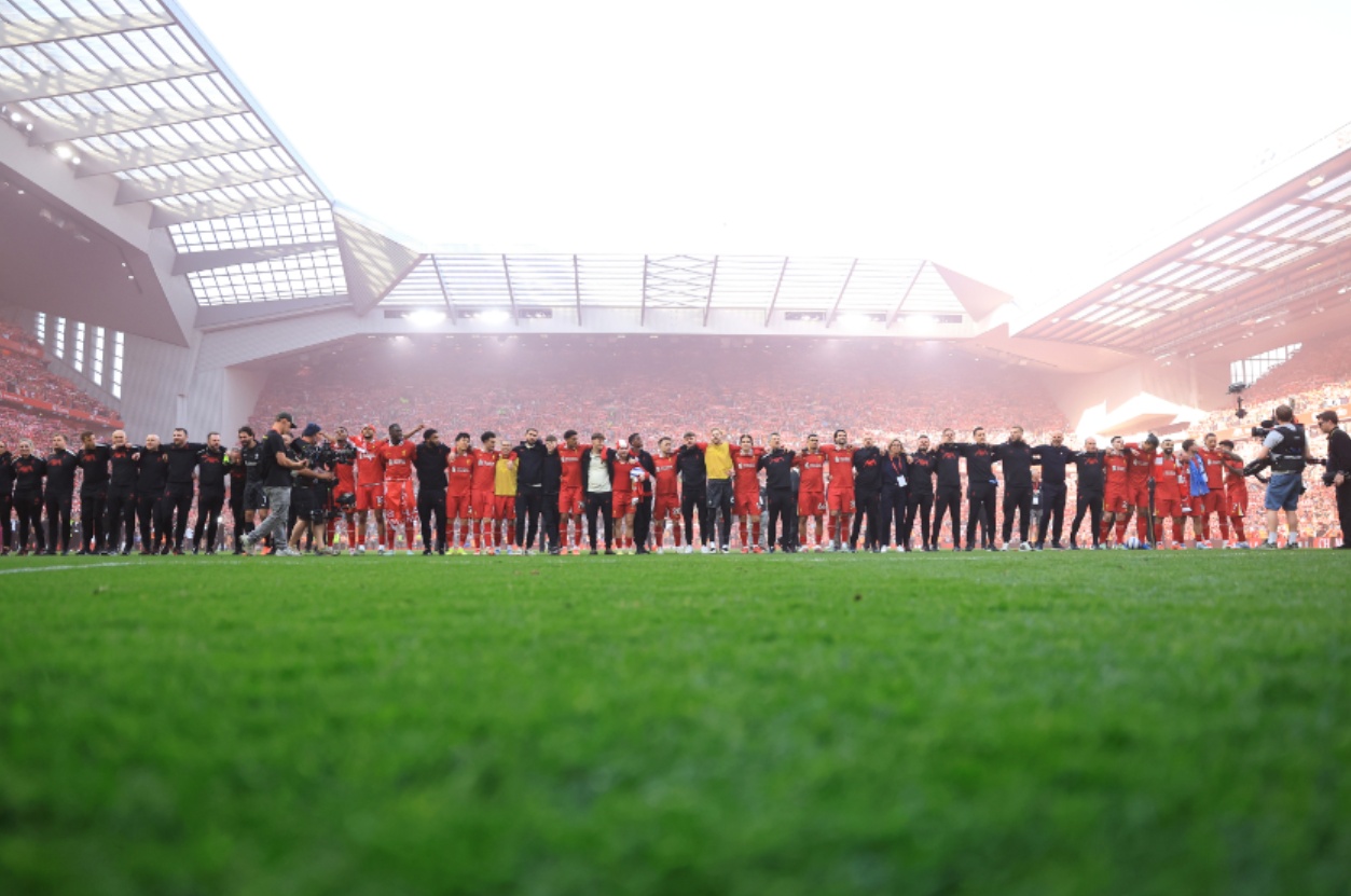 Liverpool players celebrate at Anfield after winning the Premier League