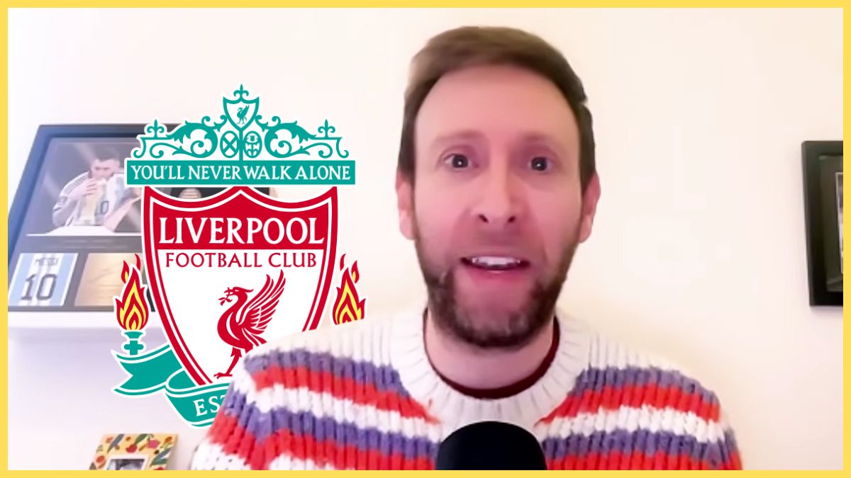 Ben Jacobs speaks into a microphone in front of the Liverpool club crest.