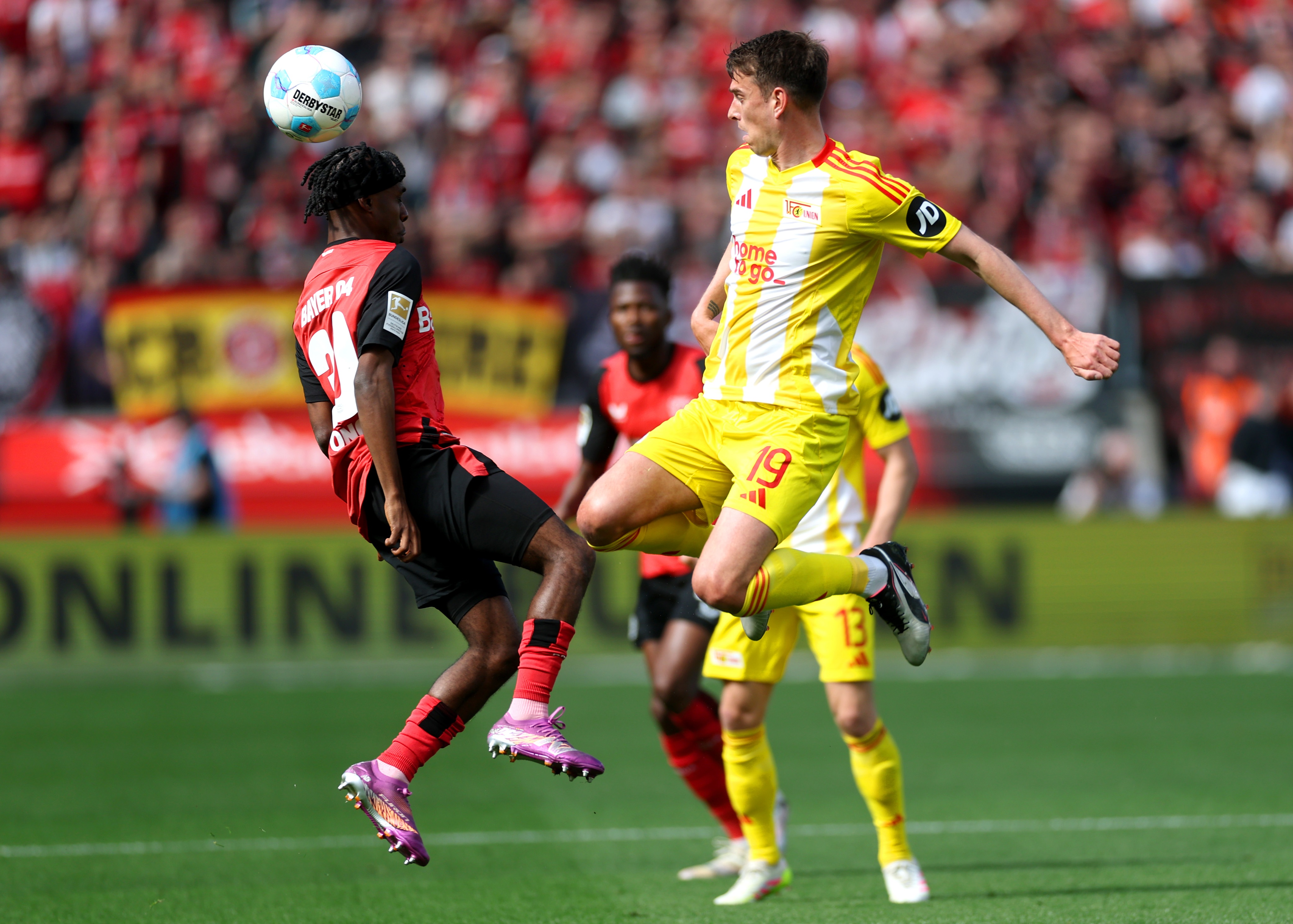 Jeremie Frimpong jumps in the air to head the ball.