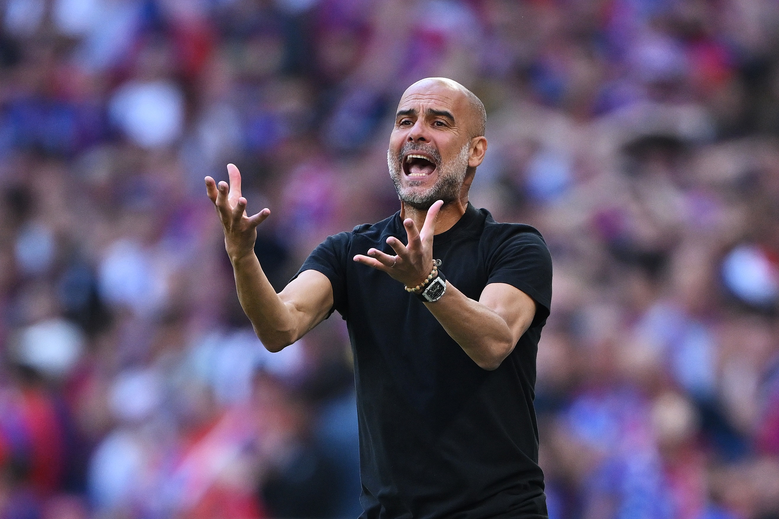 Pep Guardiola holds out his hands in frustration.
