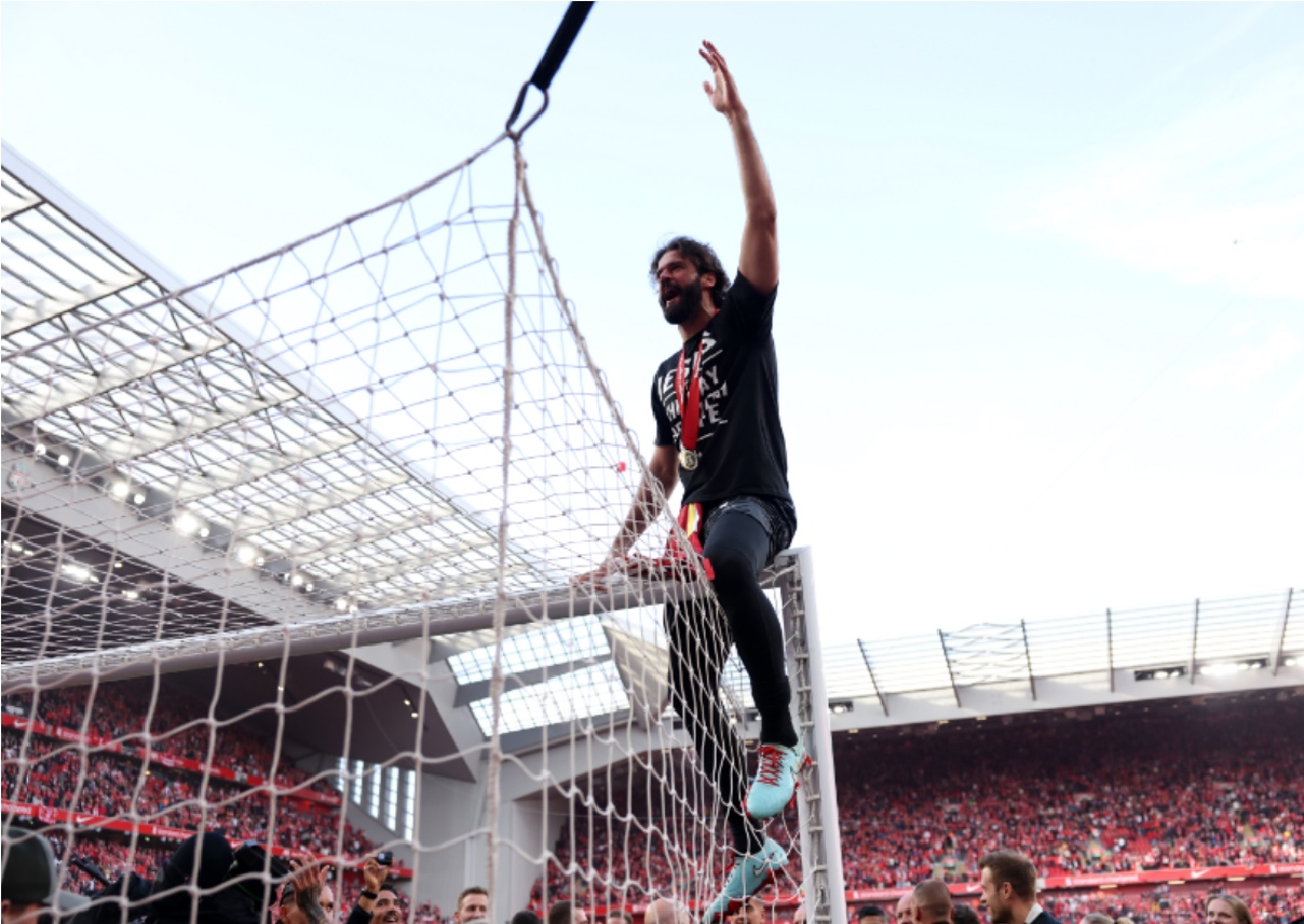 Alisson Becker celebrates after Liverpool received the Premier League trophy