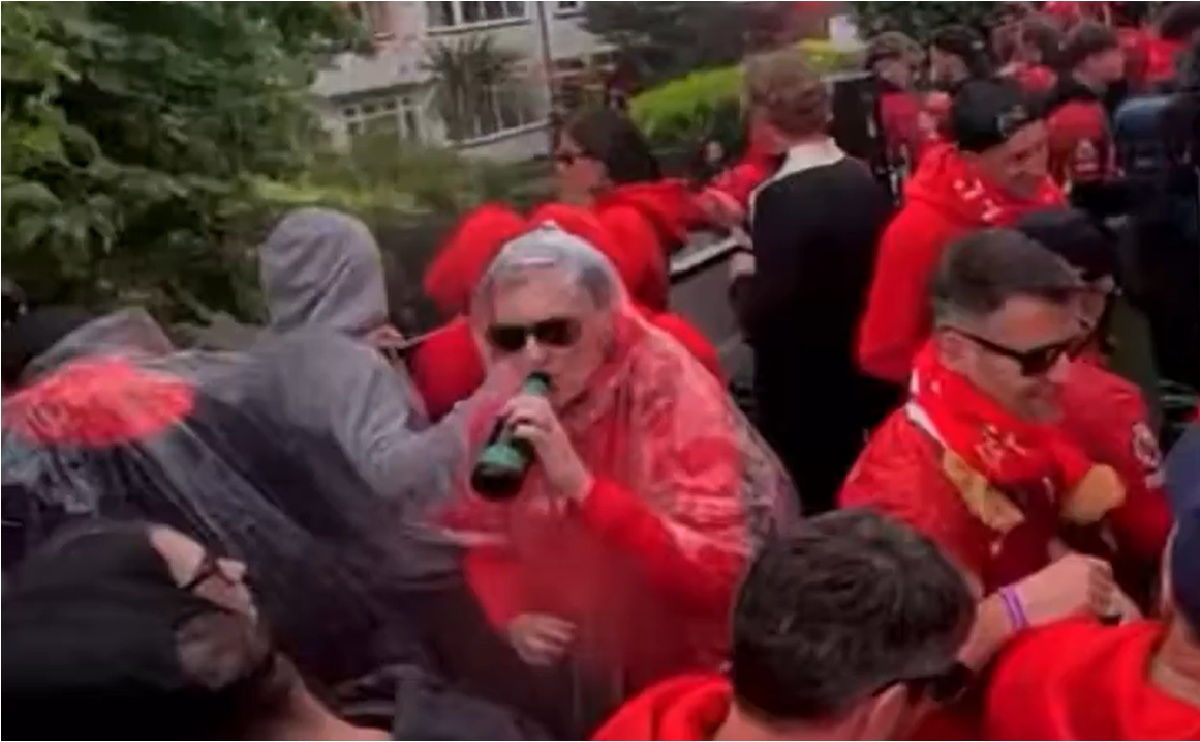 John W Henry enjoys a bottle of beer during Liverpool's Premier League victory parade