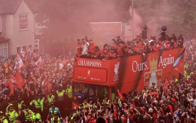 The Liverpool squad make their way through the city during the Premier League victory parade