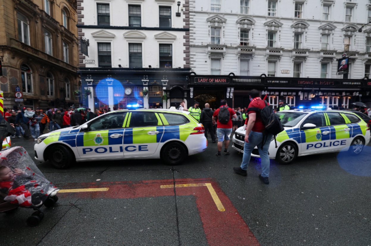 Police attend to the scene of the car crash in Liverpool on Monday evening