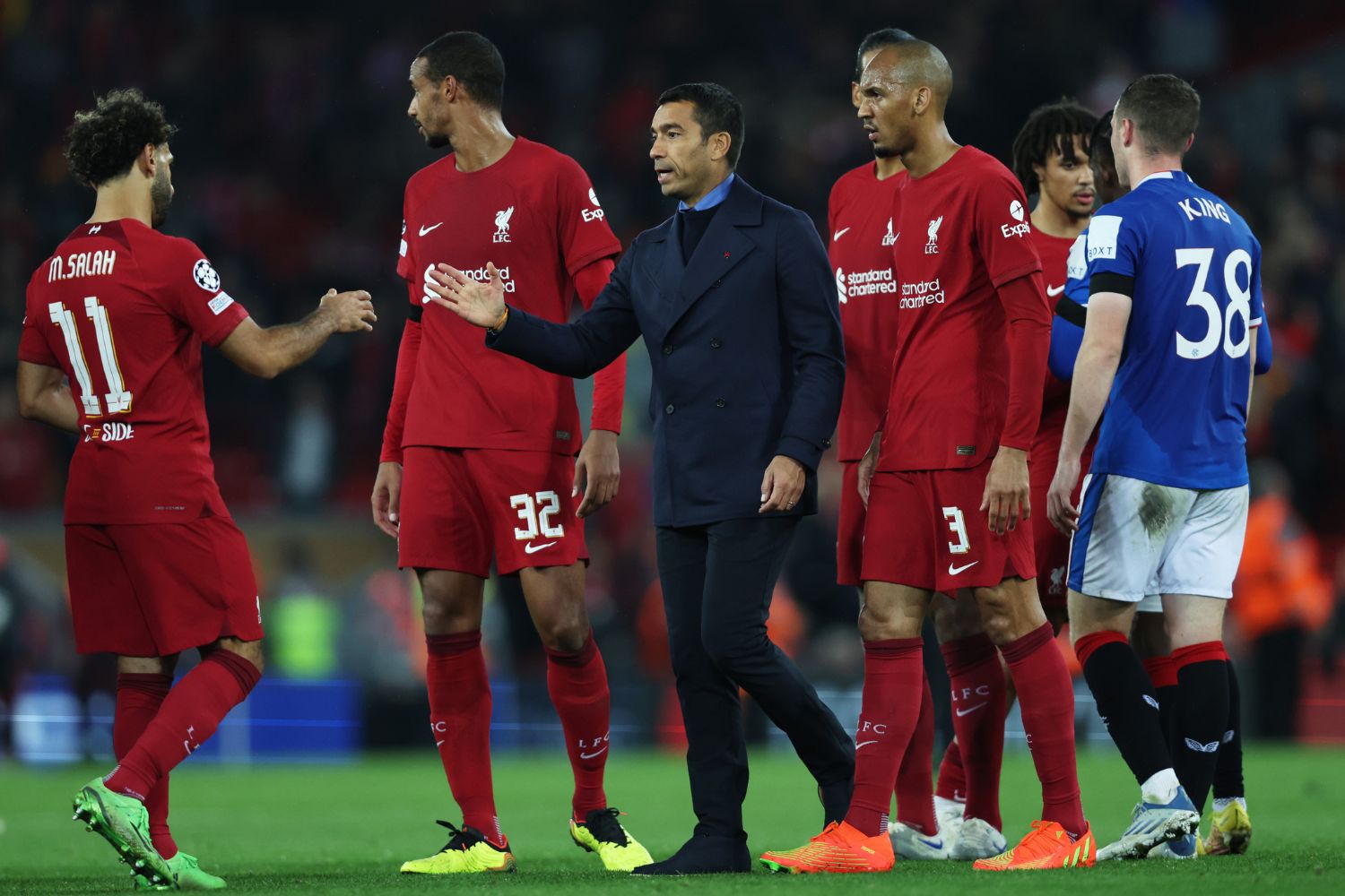 Mohamed Salah of Liverpool interacts with Giovanni van Bronckhorst, Manager of Rangers