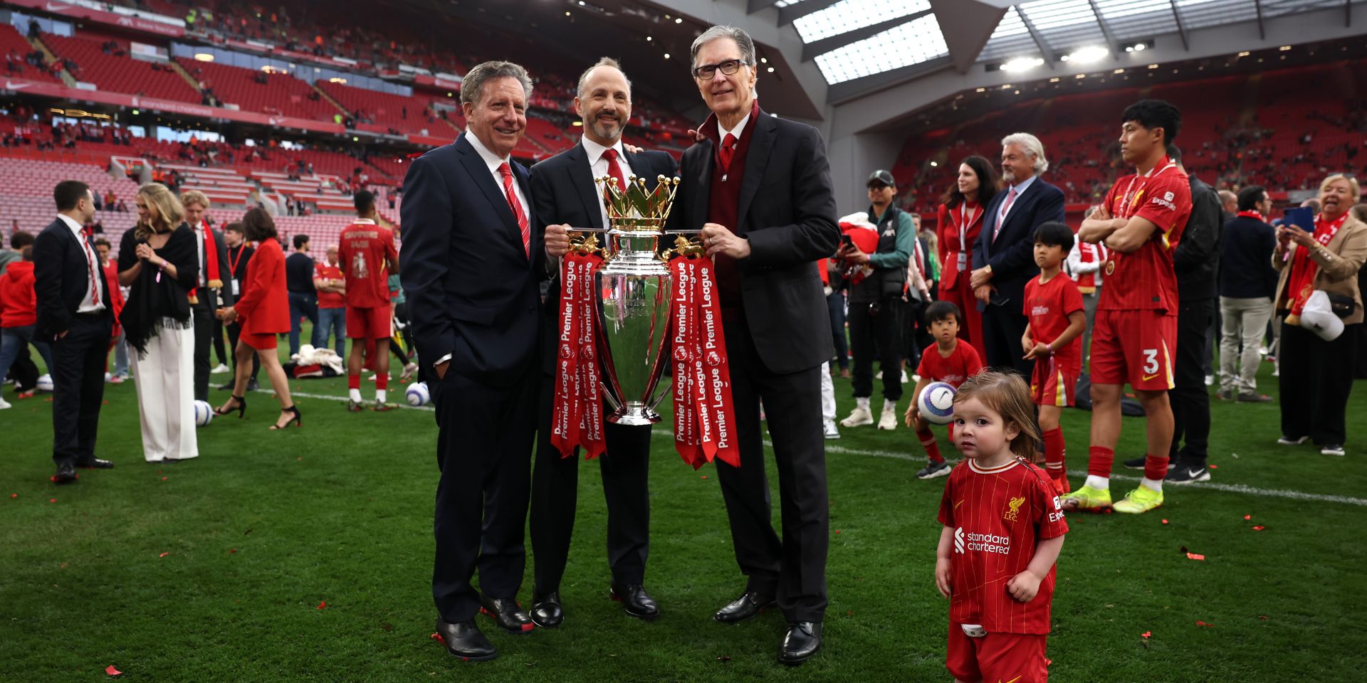 Tom Werner, Chairman of Liverpool, Michael Gordon, President of Fenway Sports Group and John Henry, Principle Owner of Liverpool pose for a photograph with the Premier League trophy, as Liverpool are crowned the Champions