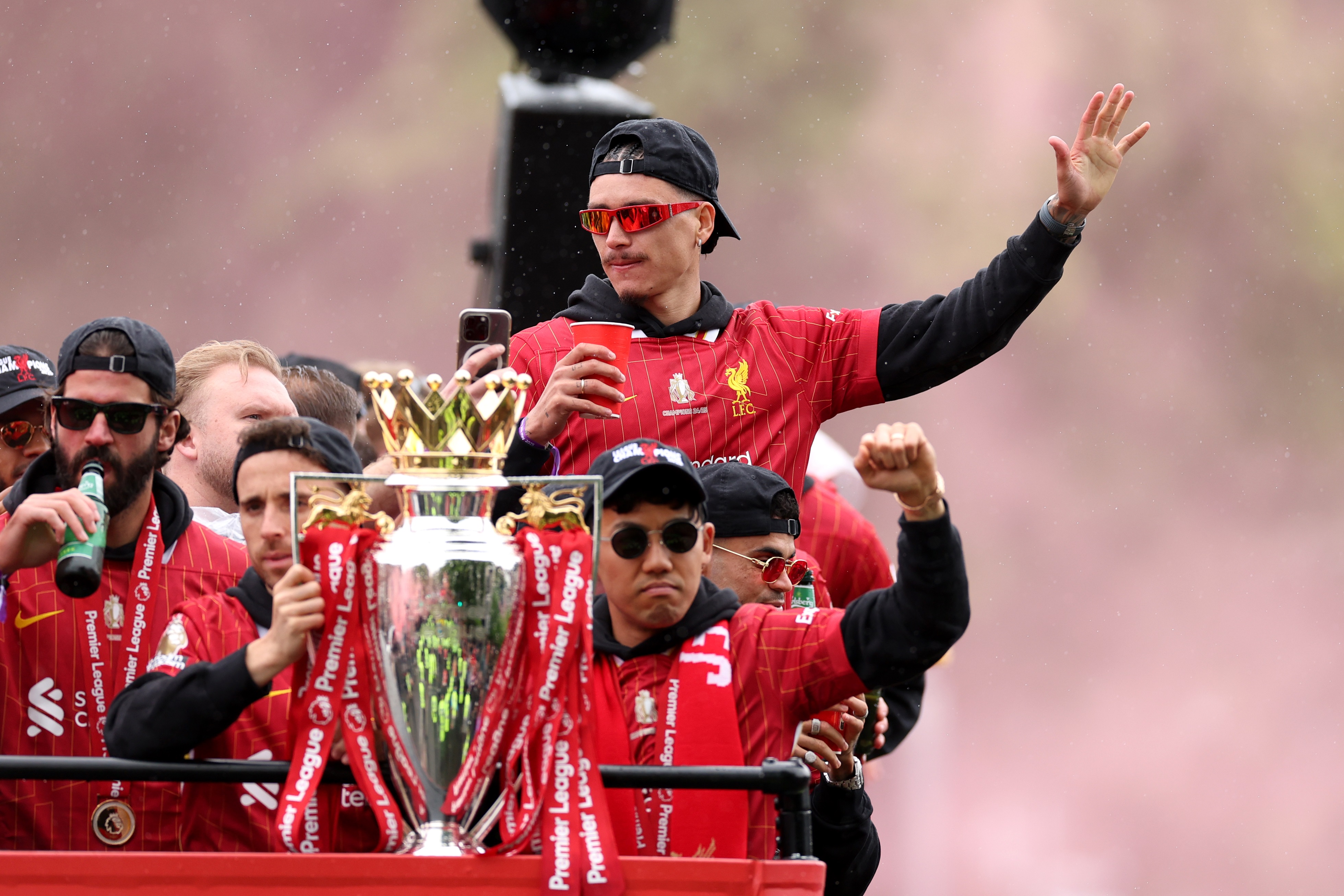 Darwin Nunez waves from an open-top bus with Liverpool players.