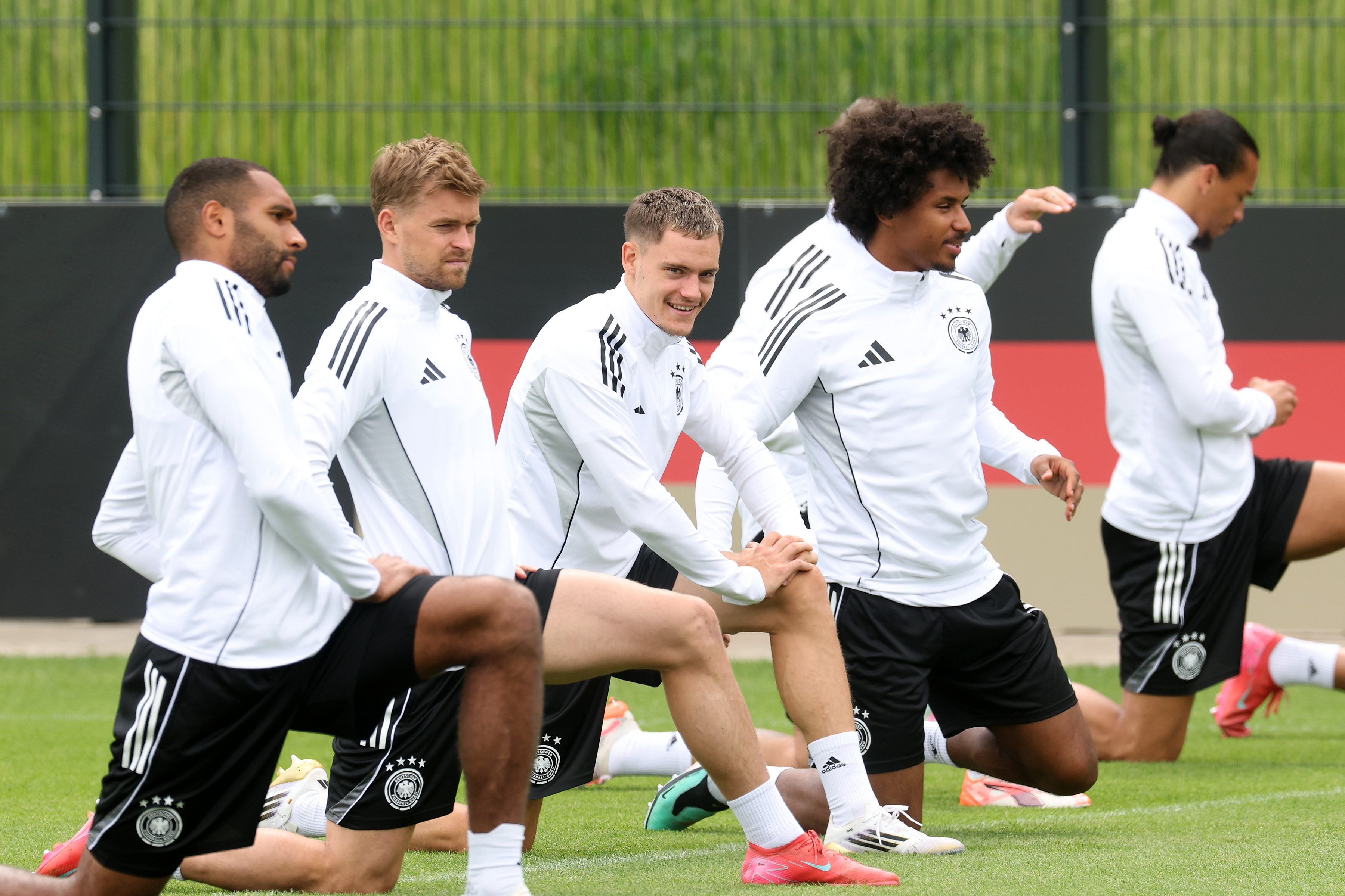 Florian Wirtz kneels down for a stretch in Germany training.
