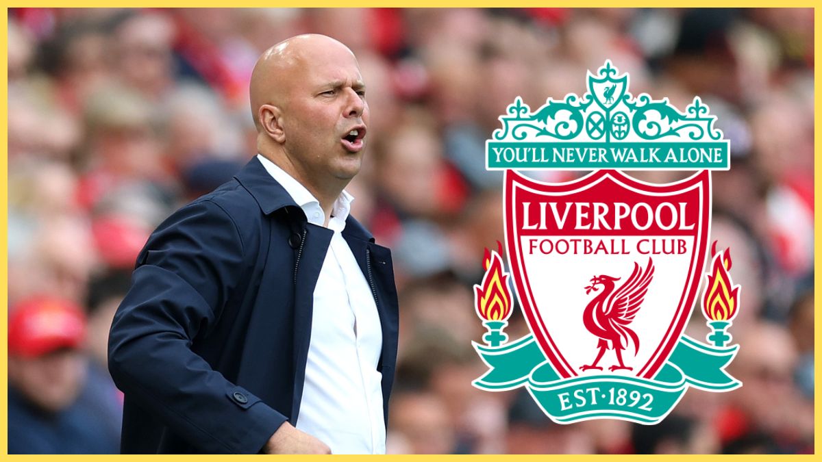 Arne Slot looks on with hands on hips next to Liverpool club crest.