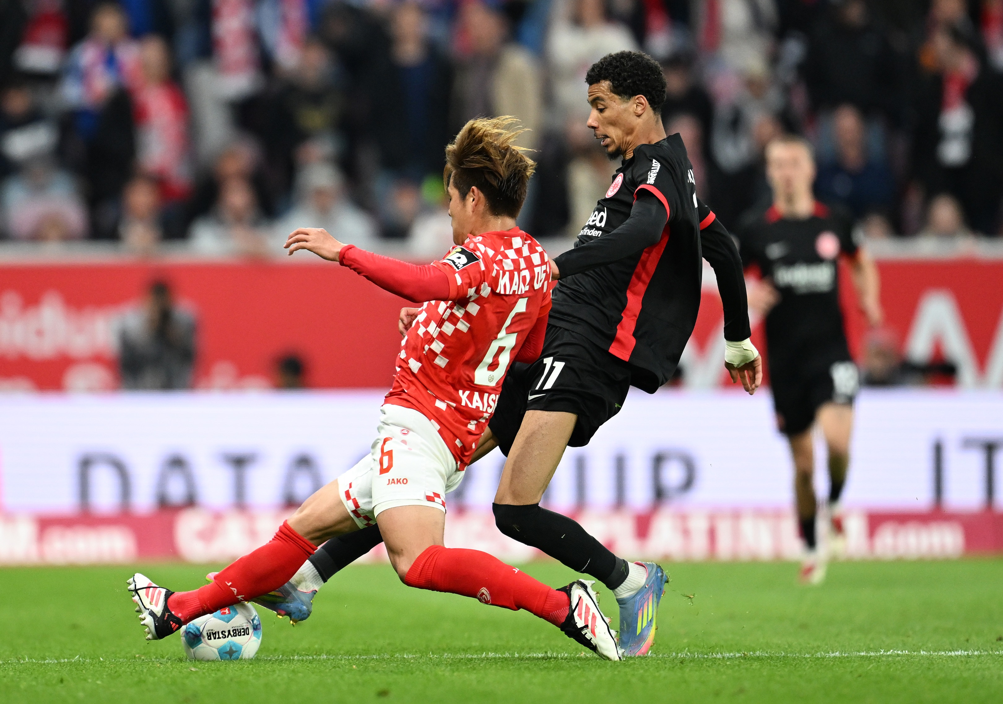 Kaishu Sano tackles Hugo Ekitike.