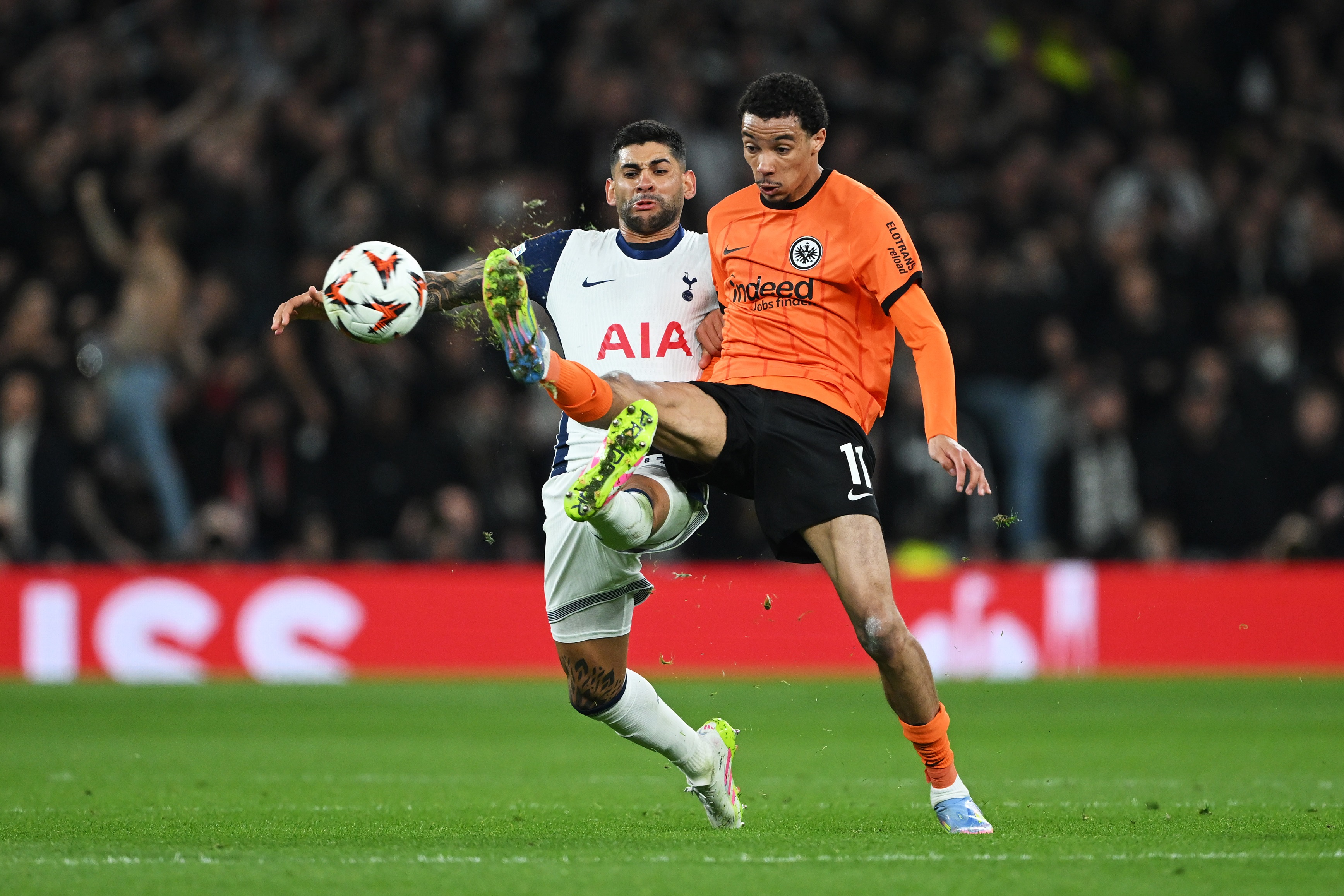Hugo Ekitike swings his right leg up high to kick the ball.