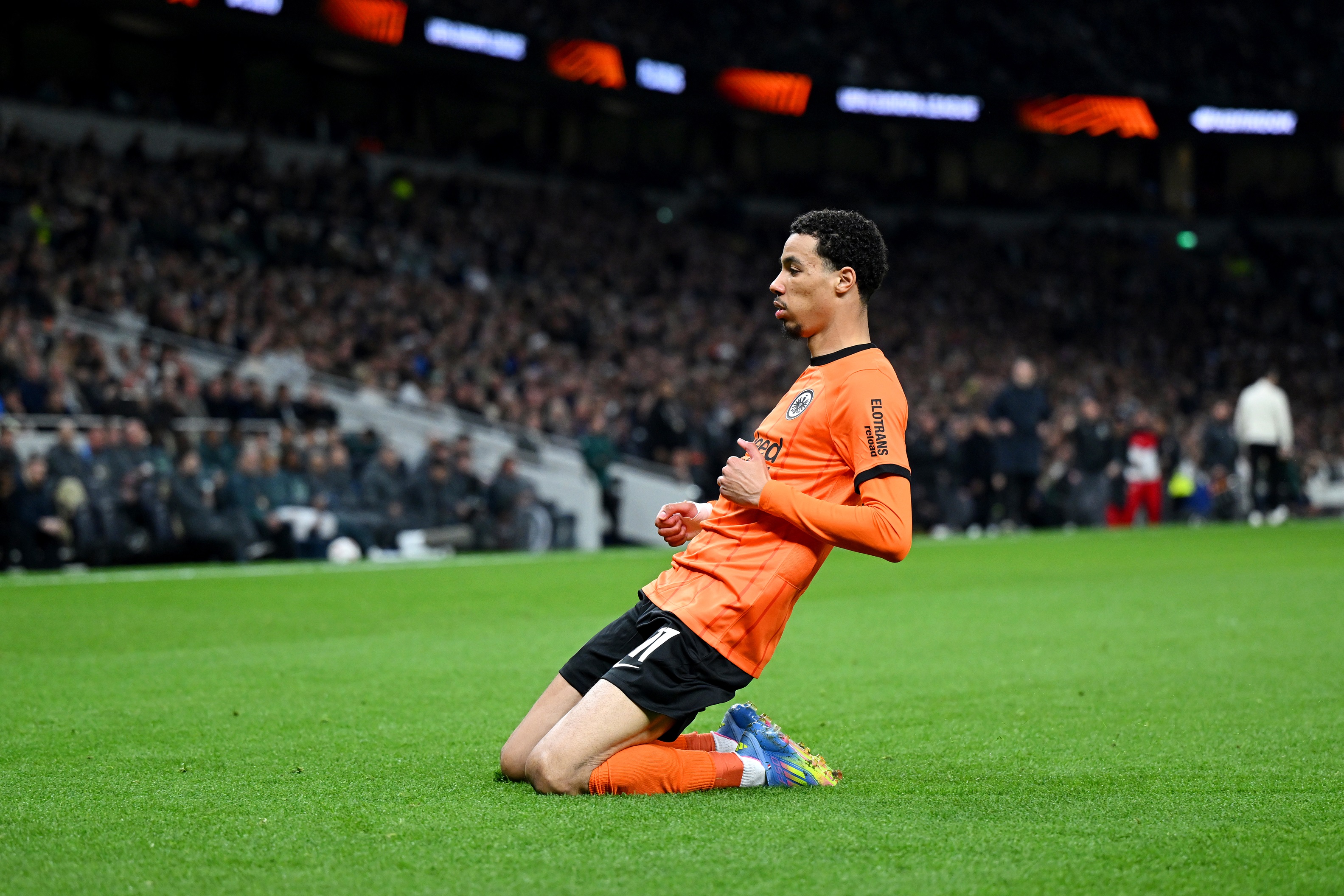 Hugo Ekitike does a knee slide after scoring a goal.
