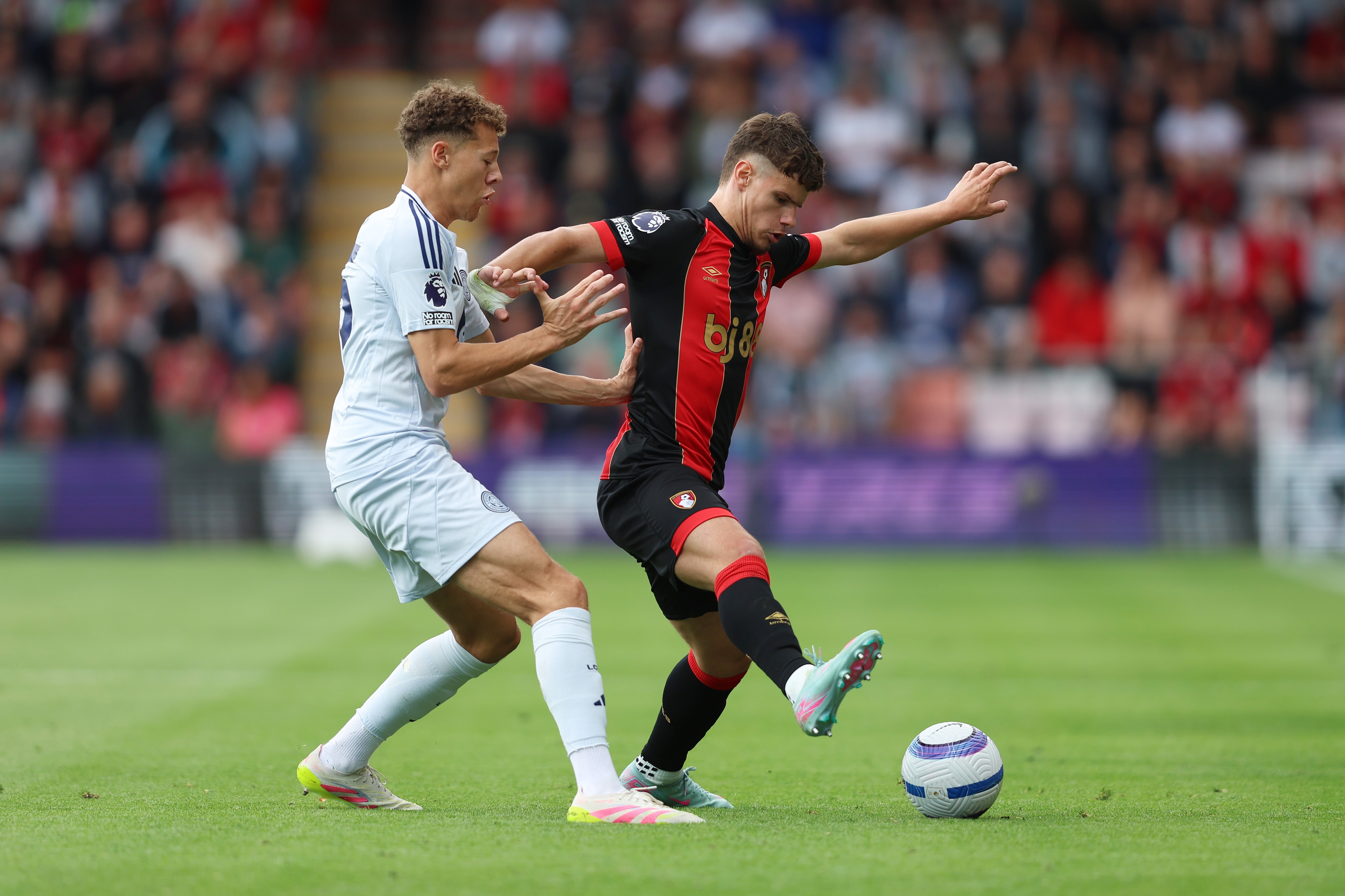 Milos Kerkez controls the ball under pressure from Kasey McAteer.