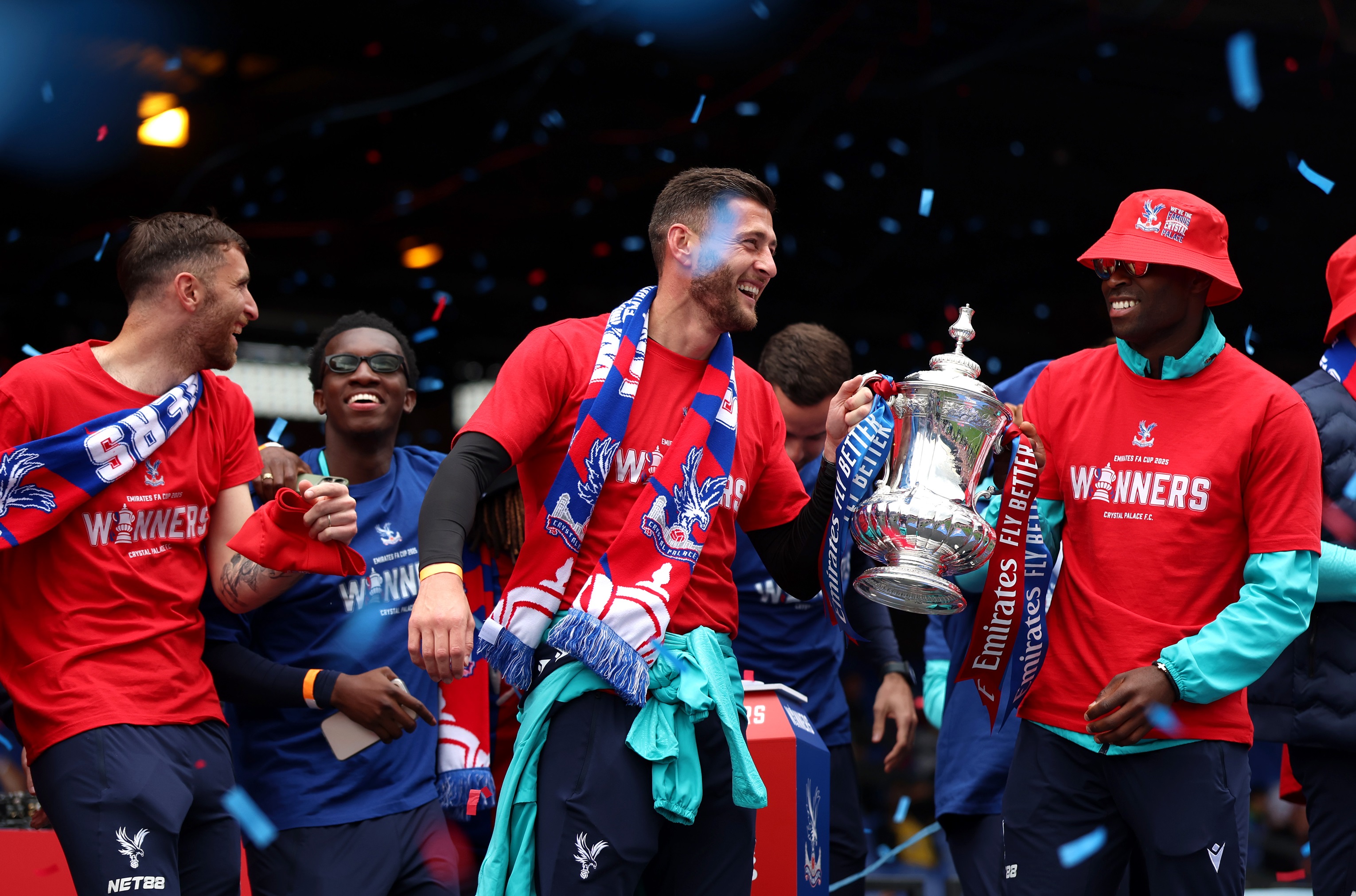 Joel Ward and a smiling Marc Guehi hold the FA Cup trophy.