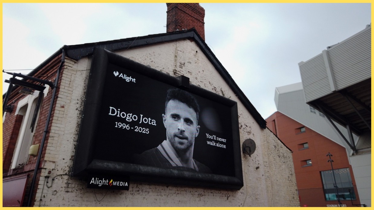 A billboard in memory of Diogo Jota is displayed on a building next to Anfield
