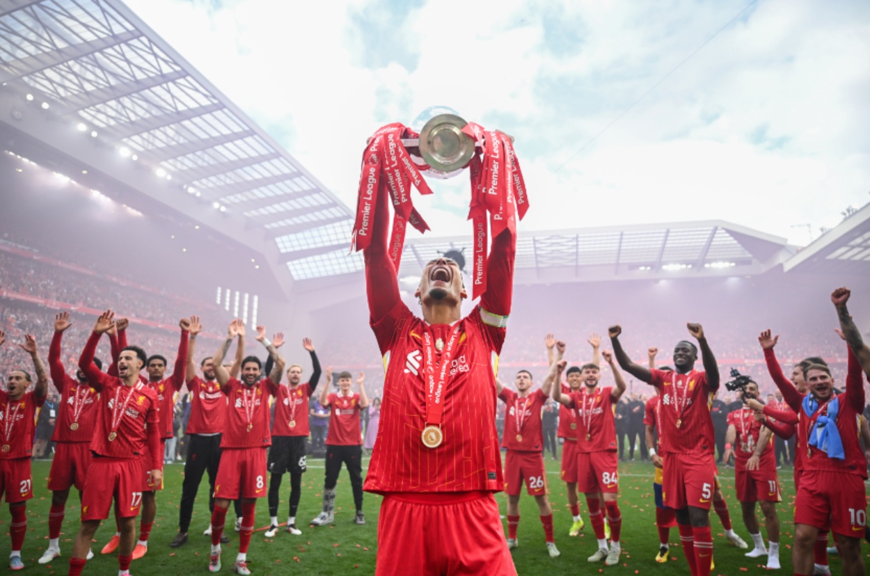 Virgil van Dijk raises the Premier League trophy at Anfield