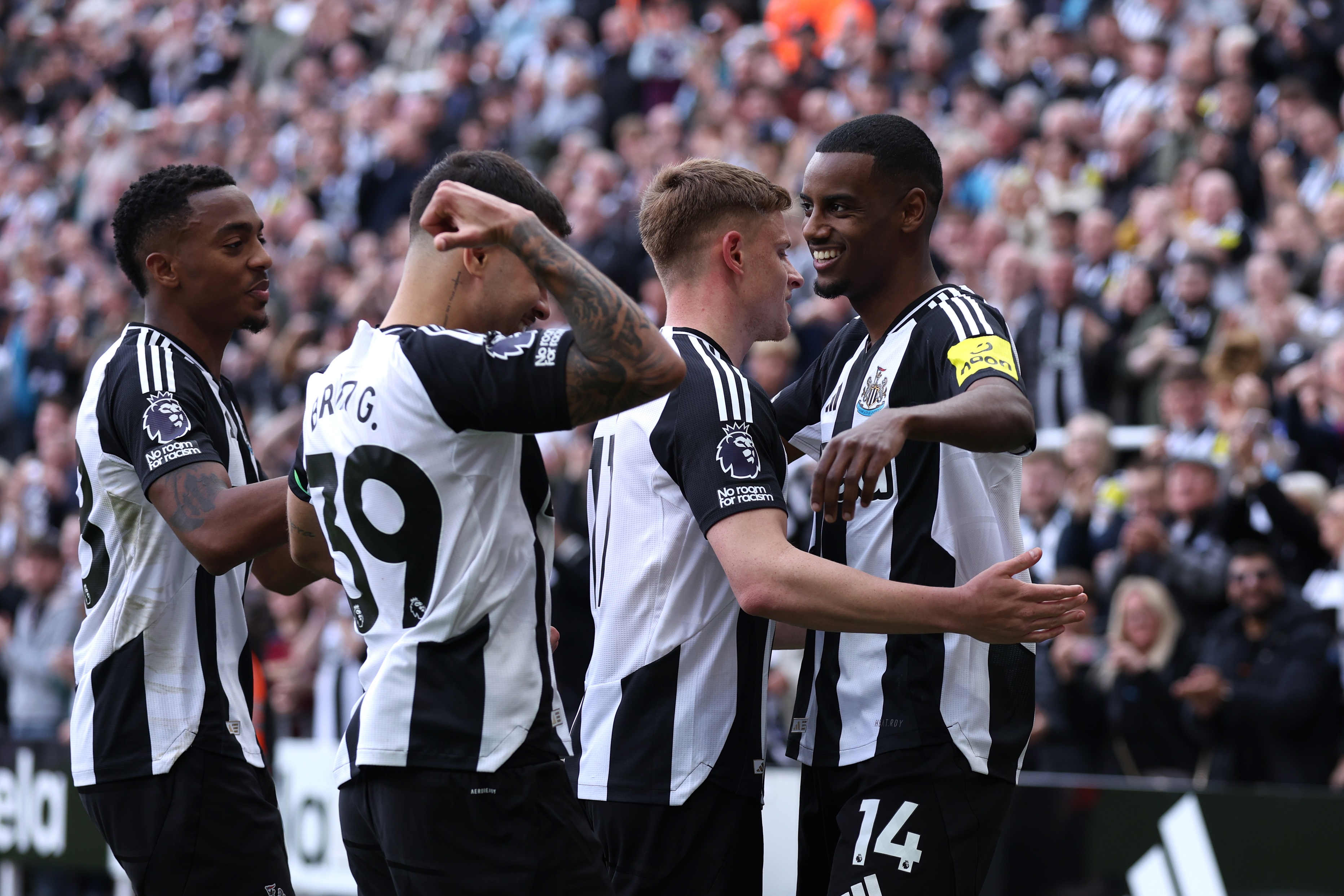 Alexander Isak hugs Newcastle teammate.