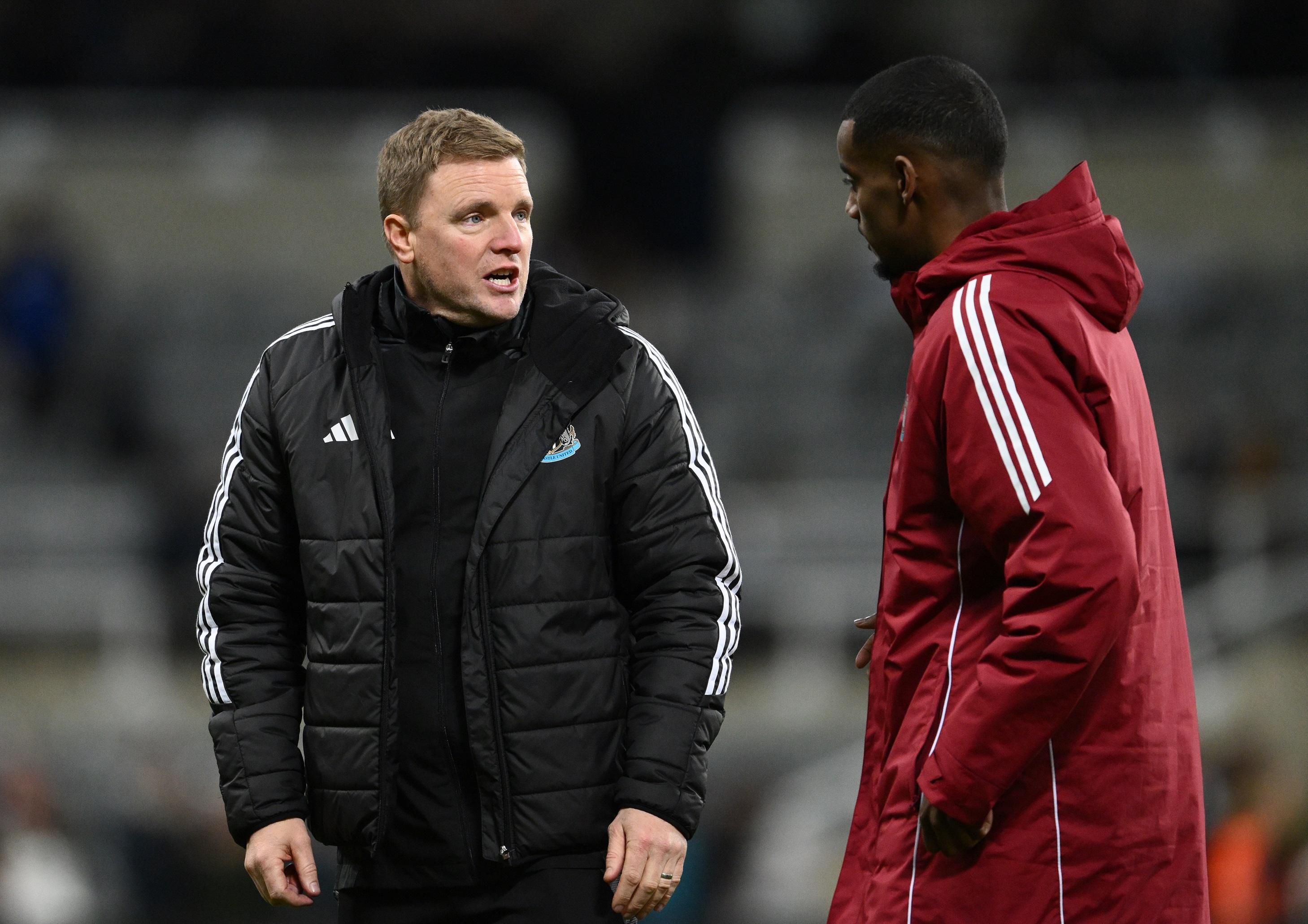 Alexander Isak speaks with Newcastle head coach Eddie Howe.