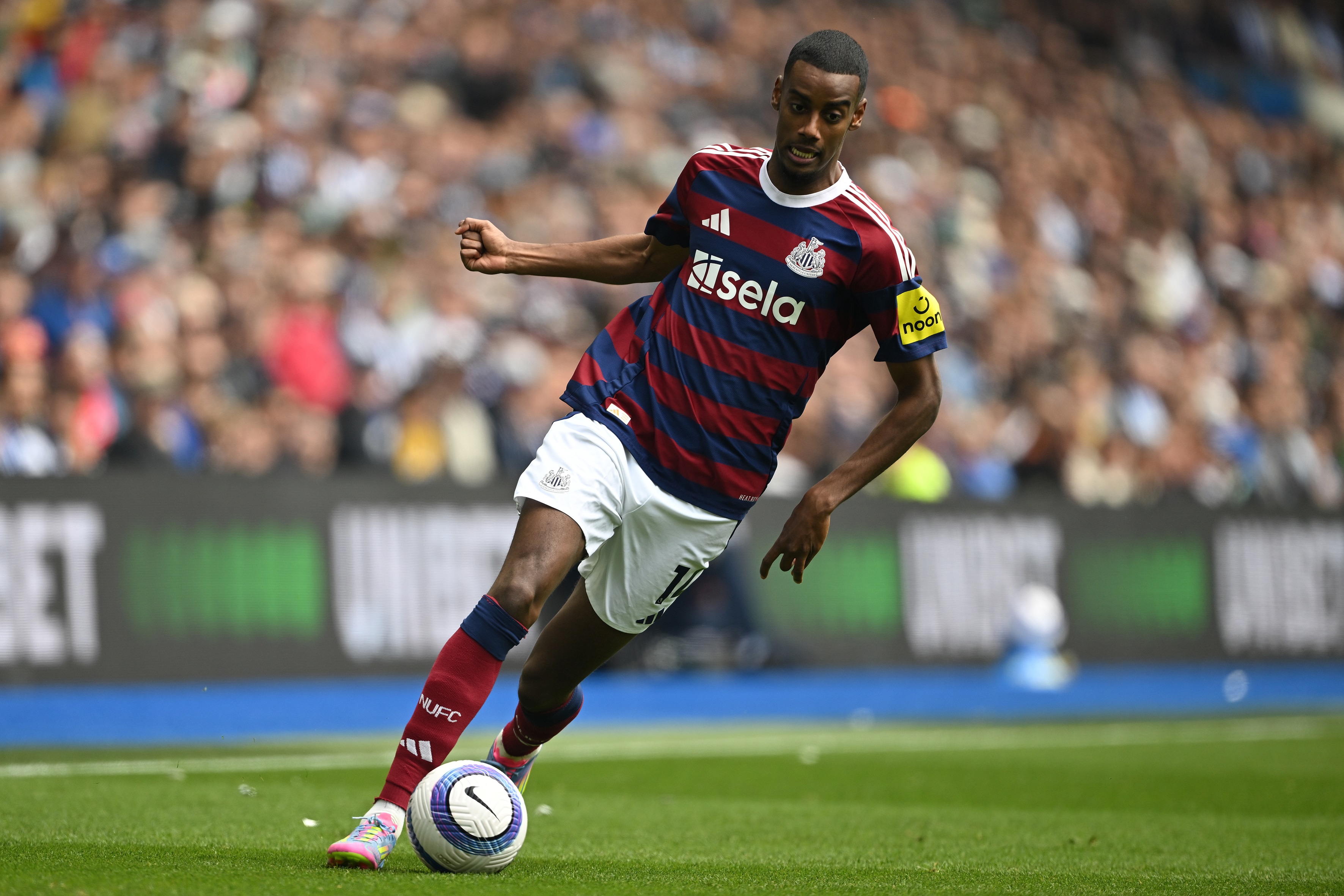 Alexander Isak runs with the ball at his feet.