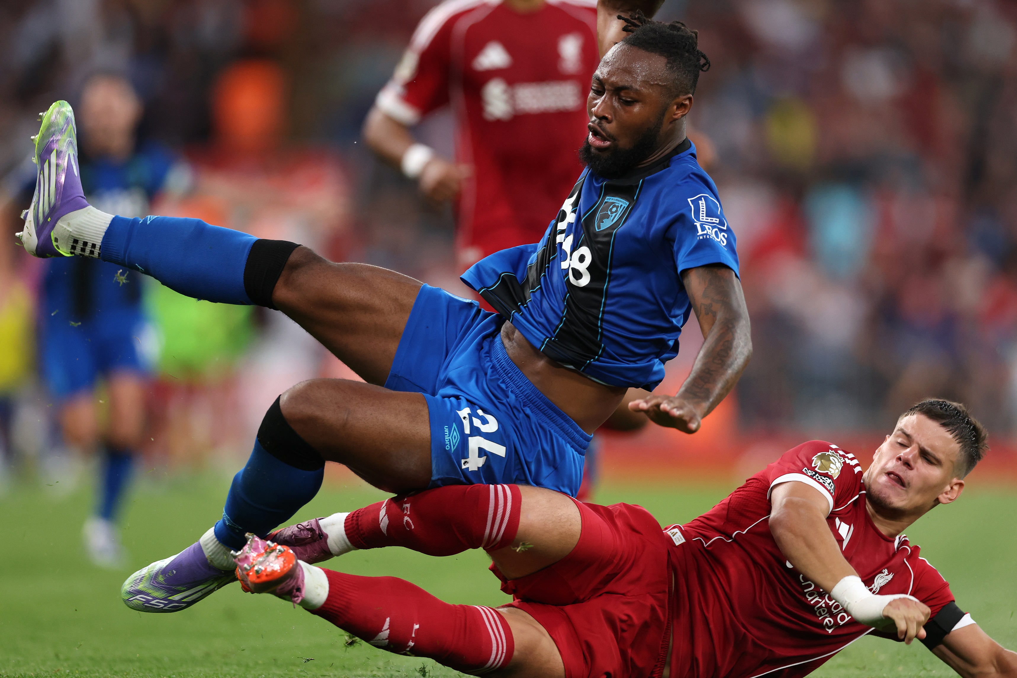 Milos Kerkez slide tackles Antoine Semenyo during Liverpool game.