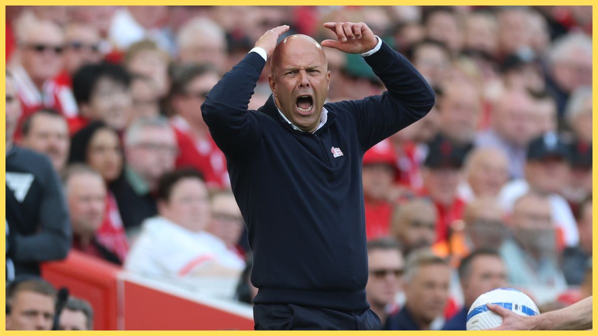 Arne Slot throws up his arms in shock during Liverpool game.