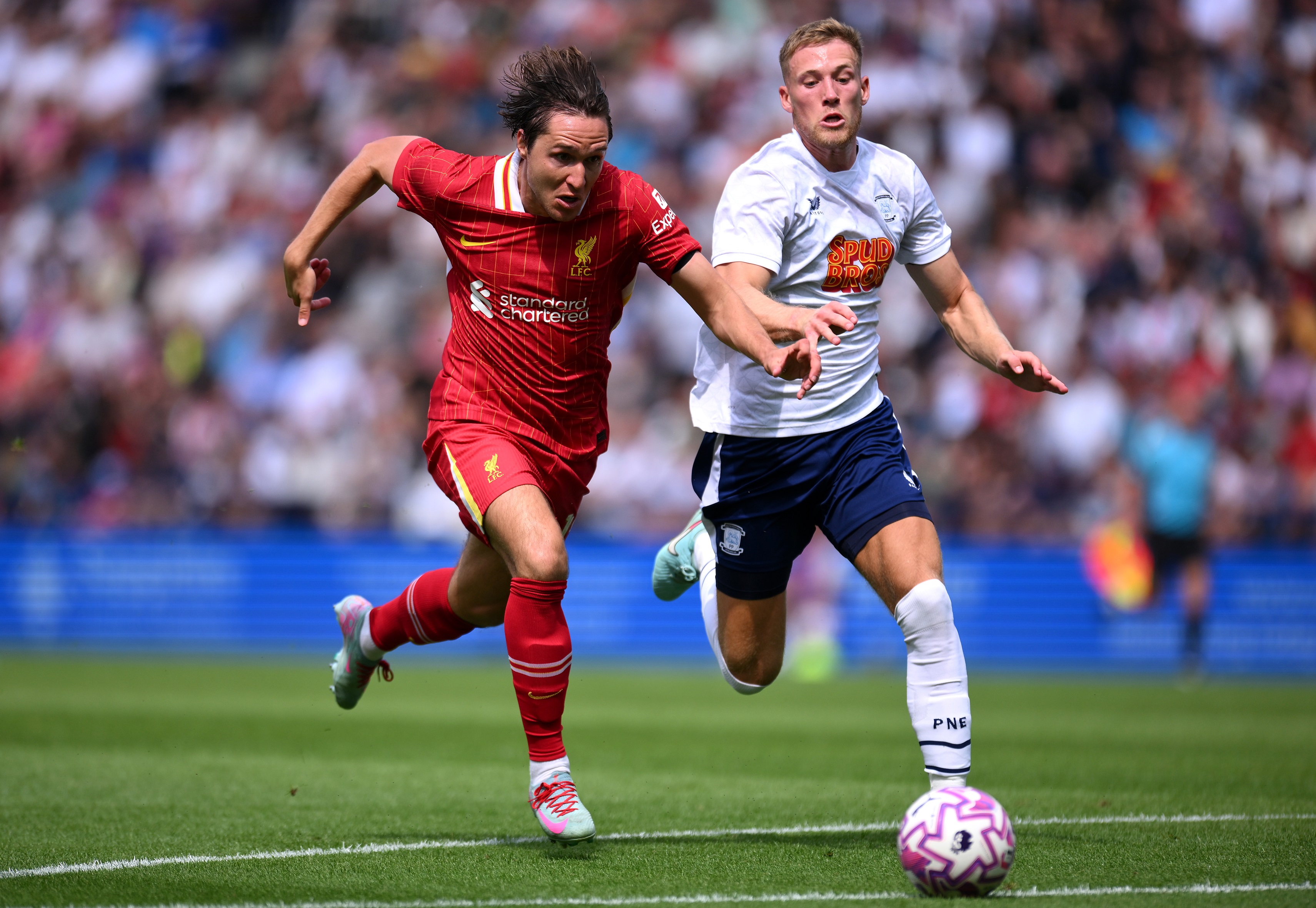 Federico Chiesa runs alongside a Preston player.
