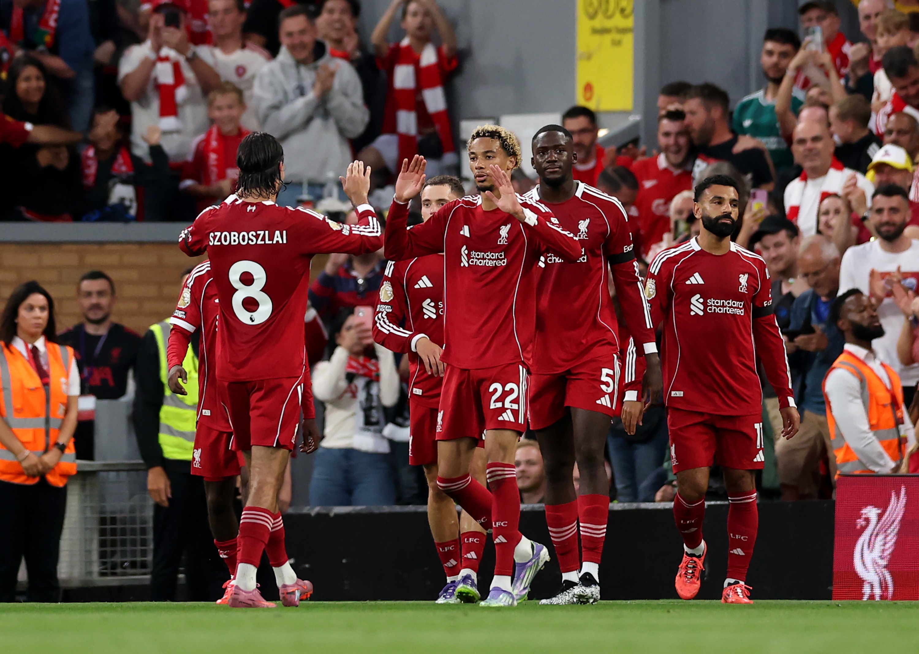 Hugo Ekitike celebrates with Dominik Szoboszlai and Liverpool teammates.