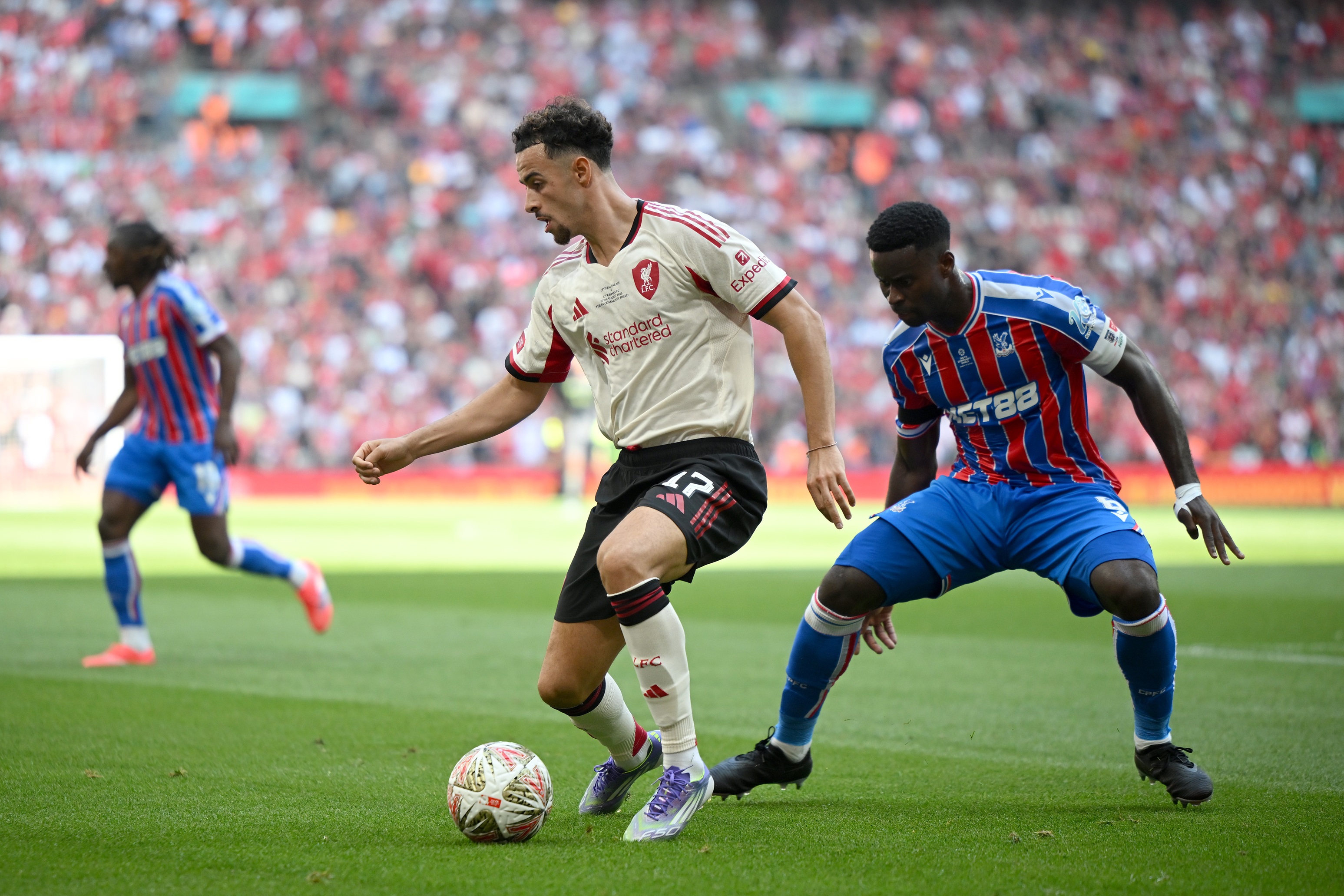 Marc Guehi stands behind Curtis Jones during Liverpool game.