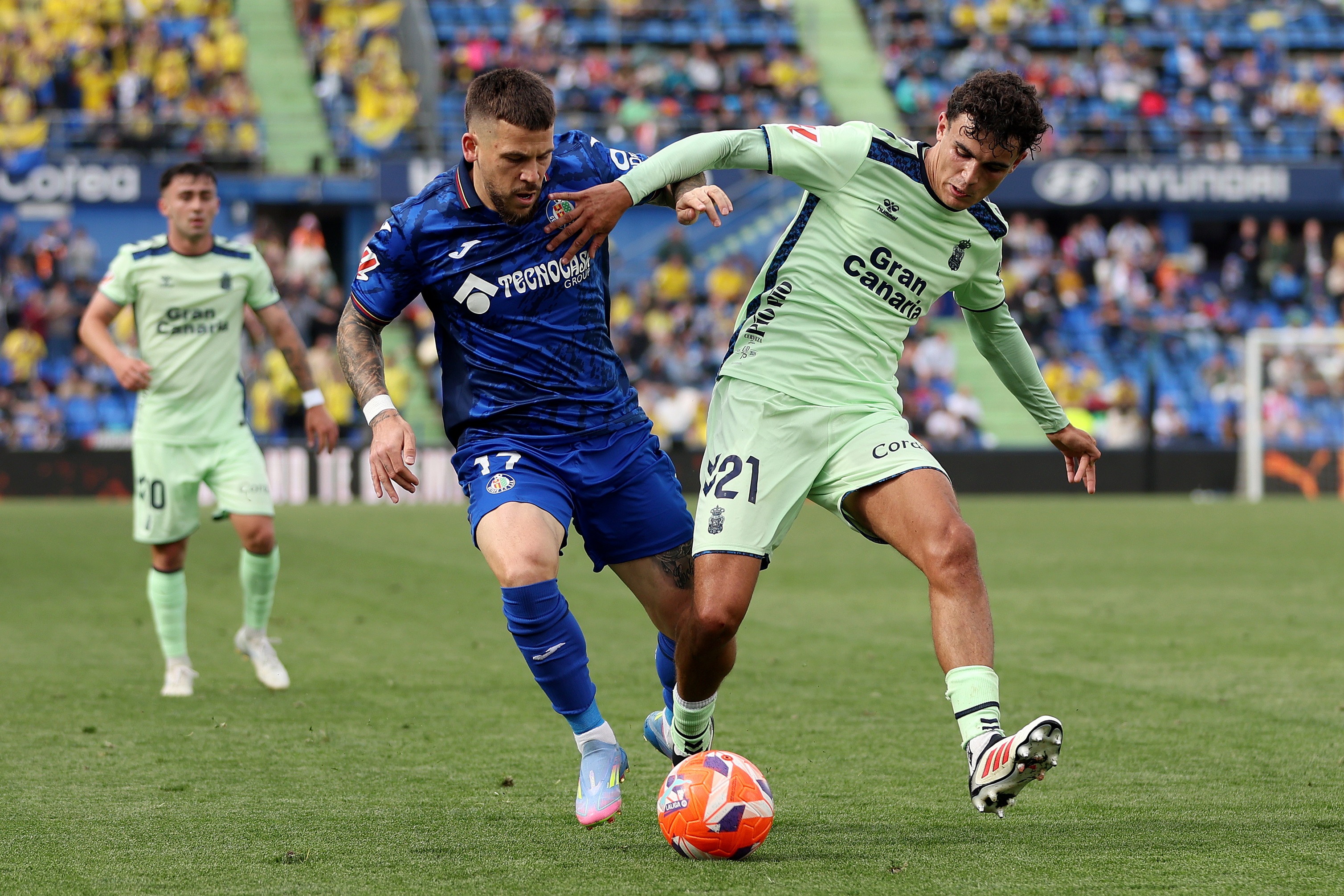Stefan Bajcetic competes for the ball with opponent.