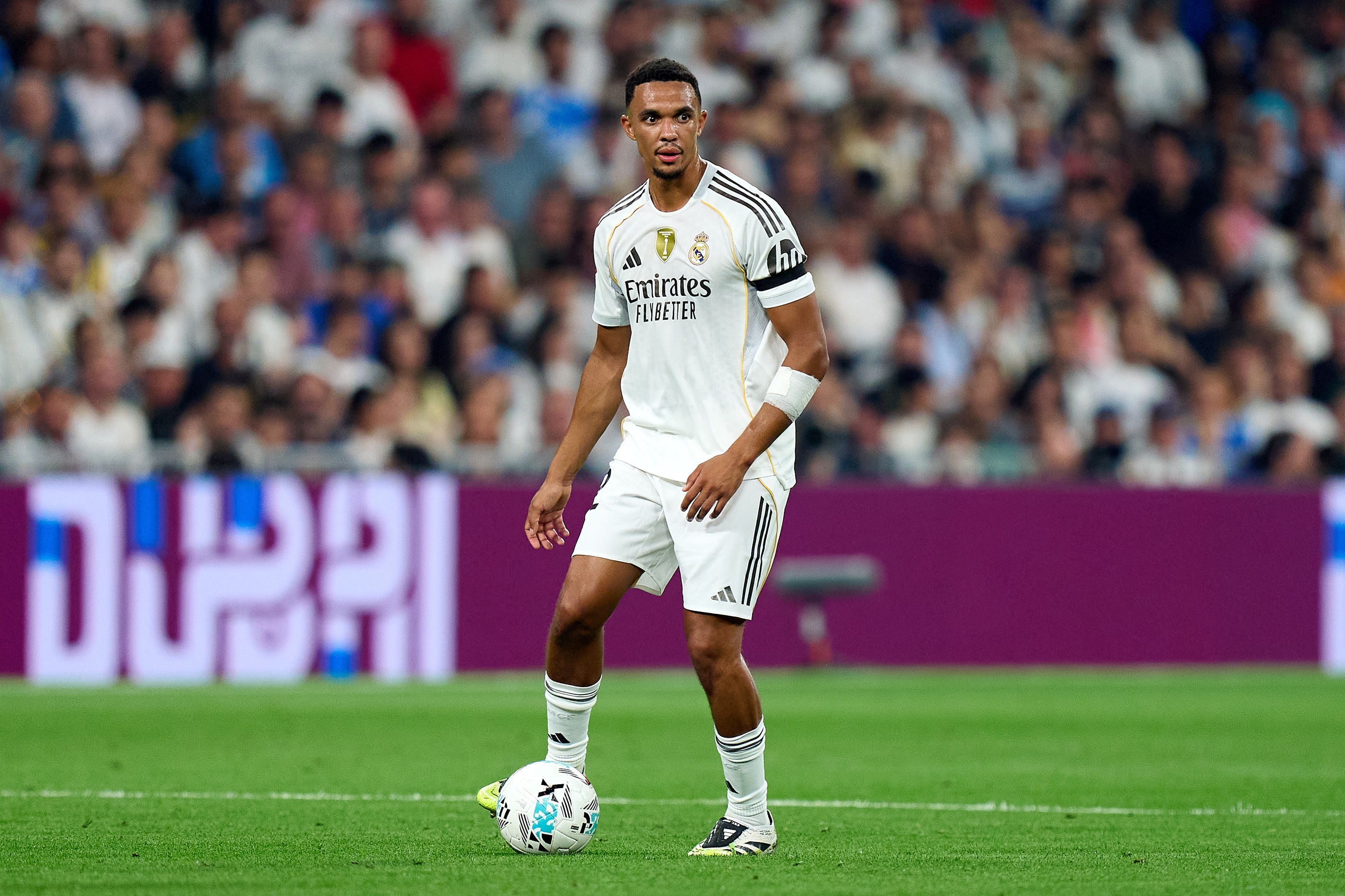 Trent Alexander-Arnold pauses with the ball at his feet.
