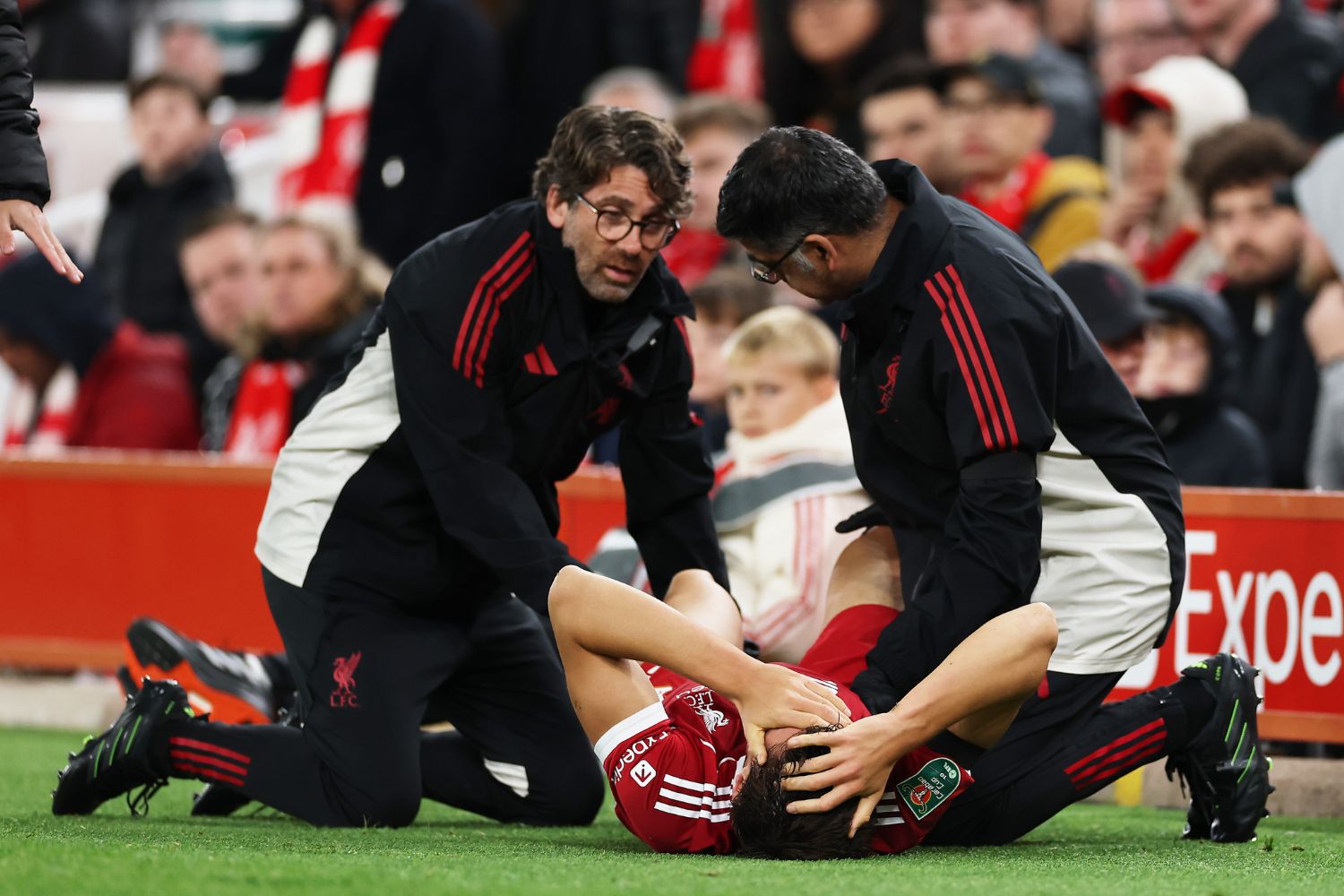 Giovanni Leoni of Liverpool receives medical treatment to an injury before being substituted off during the Carabao Cup Third Round match between Liverpool and Southampton