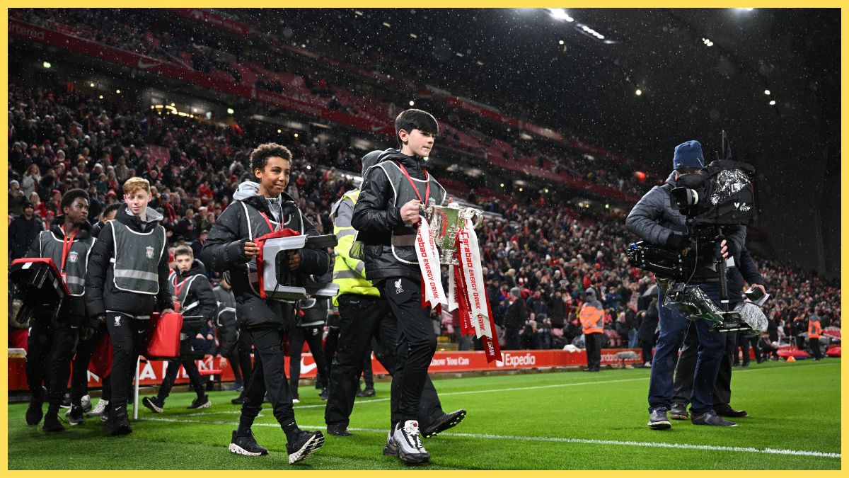 A Ballboy carries the Carabao Cup around the pitch prior to the Emirates FA Cup Fifth Round match between Liverpool and Southampton at Anfield on February 28, 2024