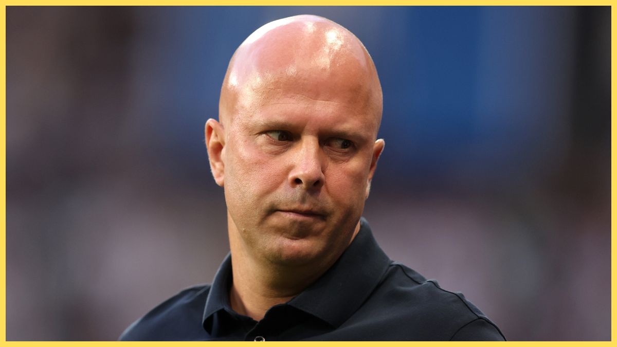 Arne Slot looks down during Premier League game.