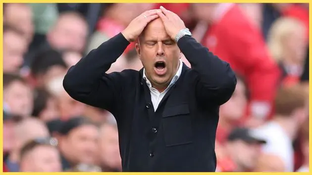 Arne Slot has hands on head and mouth open in frustration.