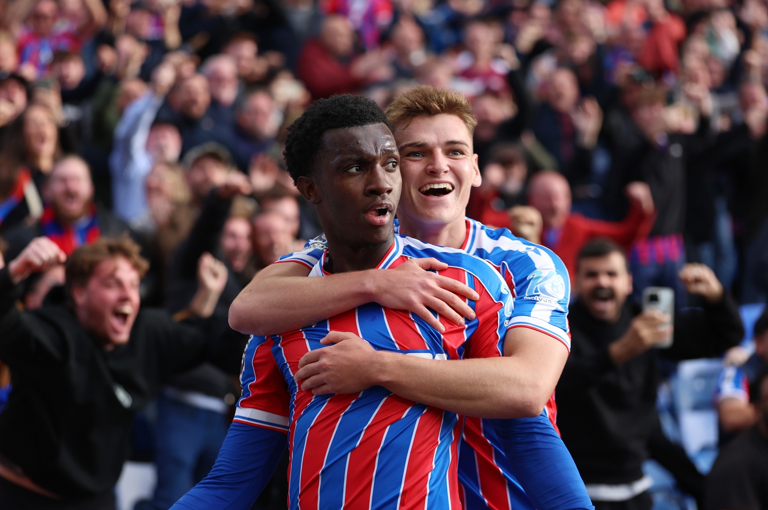 Eddie Nketiah celebrates his last-gasp winner against Liverpool with Justin Devenny