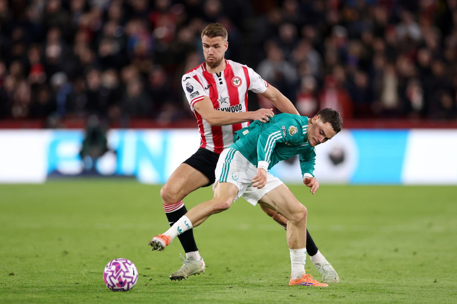 Florian Wirtz of Liverpool is challenged by Kristoffer Ajer of Brentford